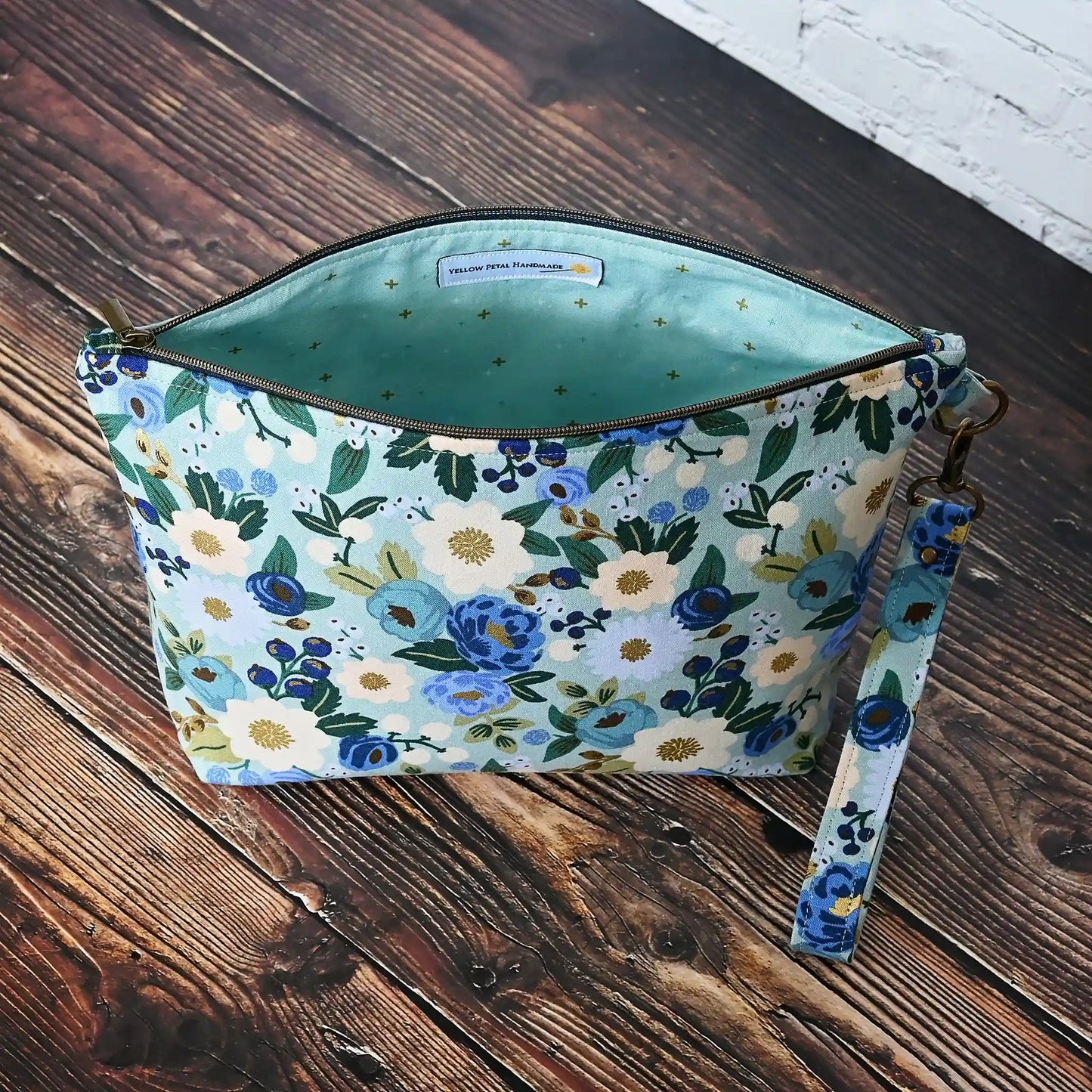 Beautiful pouch in an aqua floral fabric with gold detailing by Rifle Paper Co. Handmade in Nova Scotia, Canada by Yellow Petal Handmade.