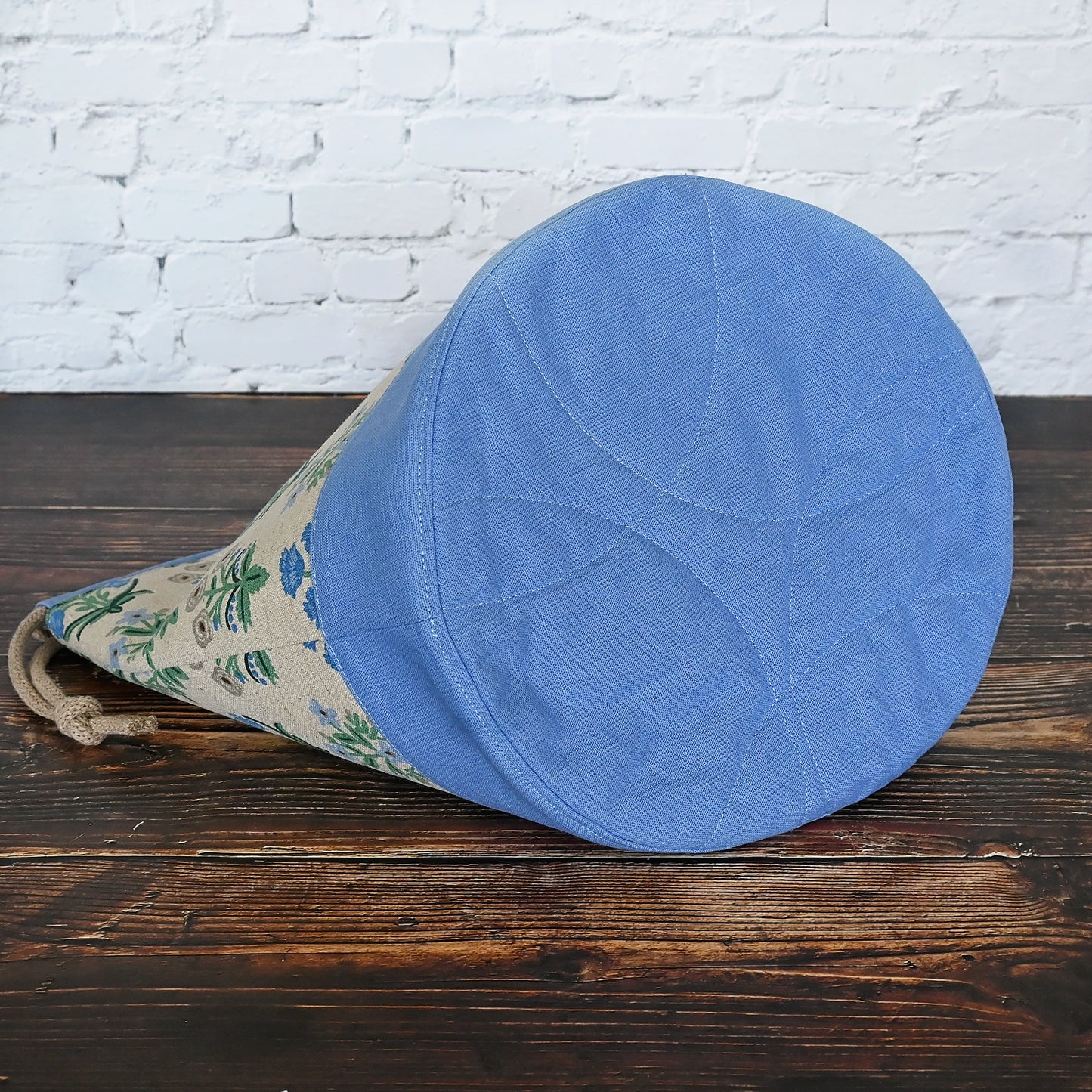 Canvas bucket bag in a pretty floral and periwinkle canvas/linen combinations. Made with plenty of interior pockets and a quilted bottom for stability and design. Made in Canada by Yellow Petal Handmade.