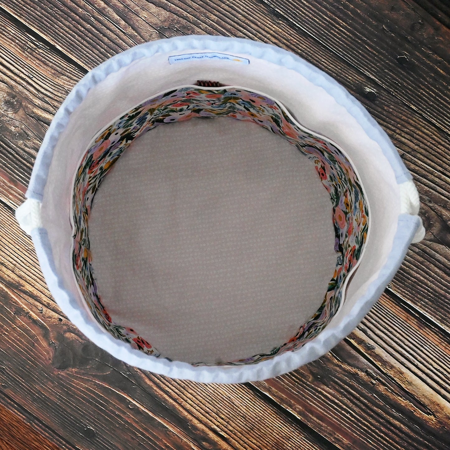 Pretty mauve and floral bucket style project bag. Made with RIfle Paper's Garden Party fabric collection in their newest pastels and paired with a lovely mauve linen from Robert Kaufman. The interior features pockets and the bottom is quilted for extra stability. This bag closes securely with a double drawstring. Made in Canada by Yellow Petal Handmade.