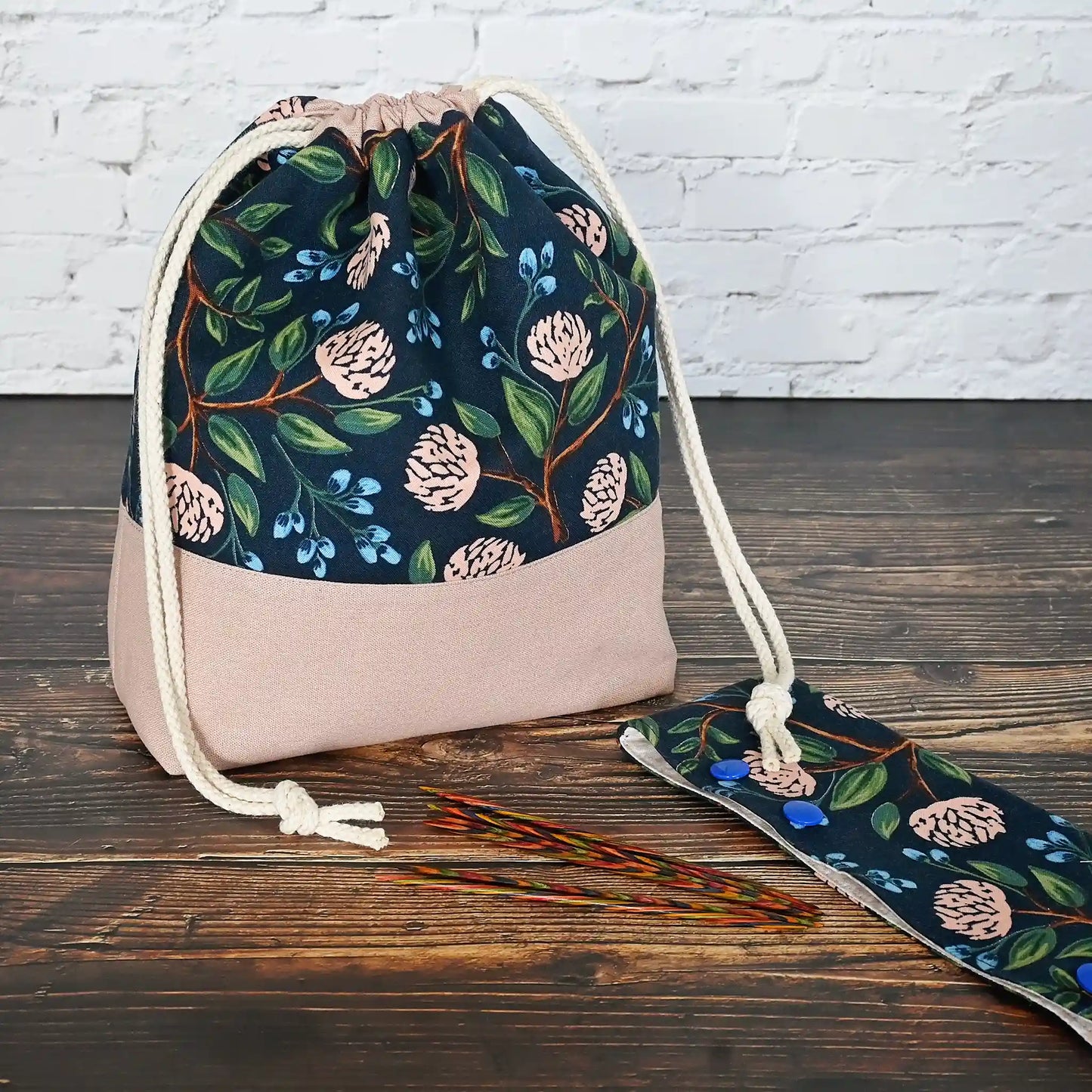 Pretty drawstring project bag made from a navy cotton with pink peonies and paired with a matching pink linen bottom. Available with or without pockets. Made by Yellow Petal Handmade in Nova Scotia, Canada.