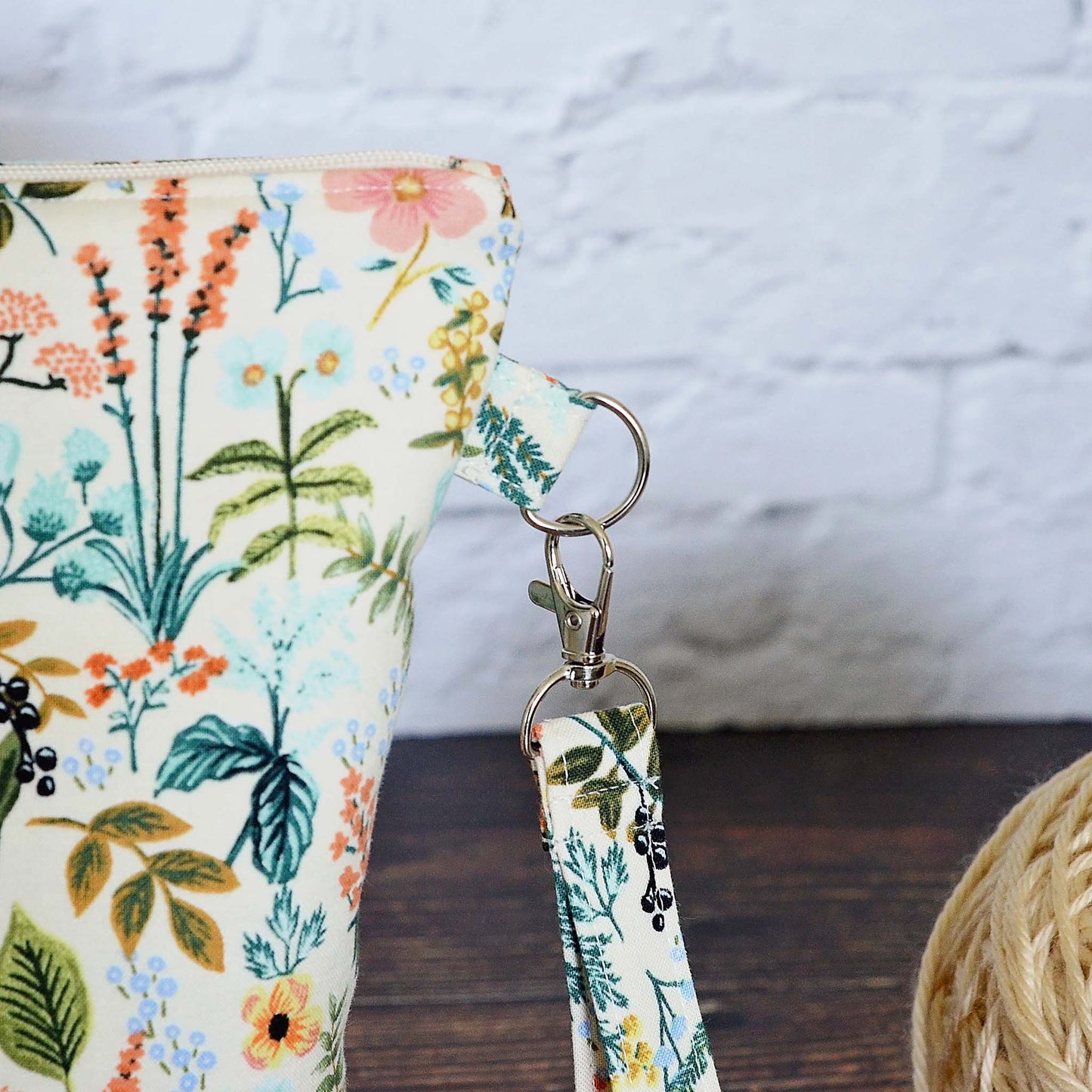 Zippered project bag in Rifle Paper Amalfi Herb Garden fabric paired with a Kaufman linen. Comes with removable strap. Made in Canada by Yellow Petal Handmade.