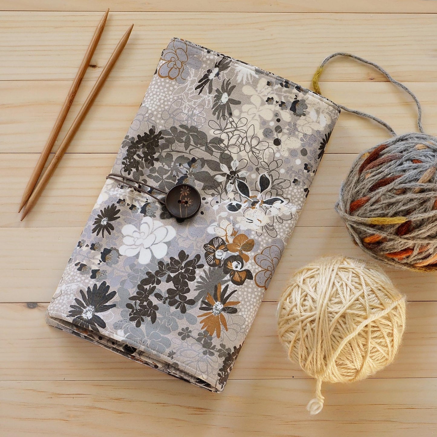 Large knitting needle tri-fold wrap in grey floral with bronze accents. Made by Yellow Petal Handmade in Nova Scotia, Canada.