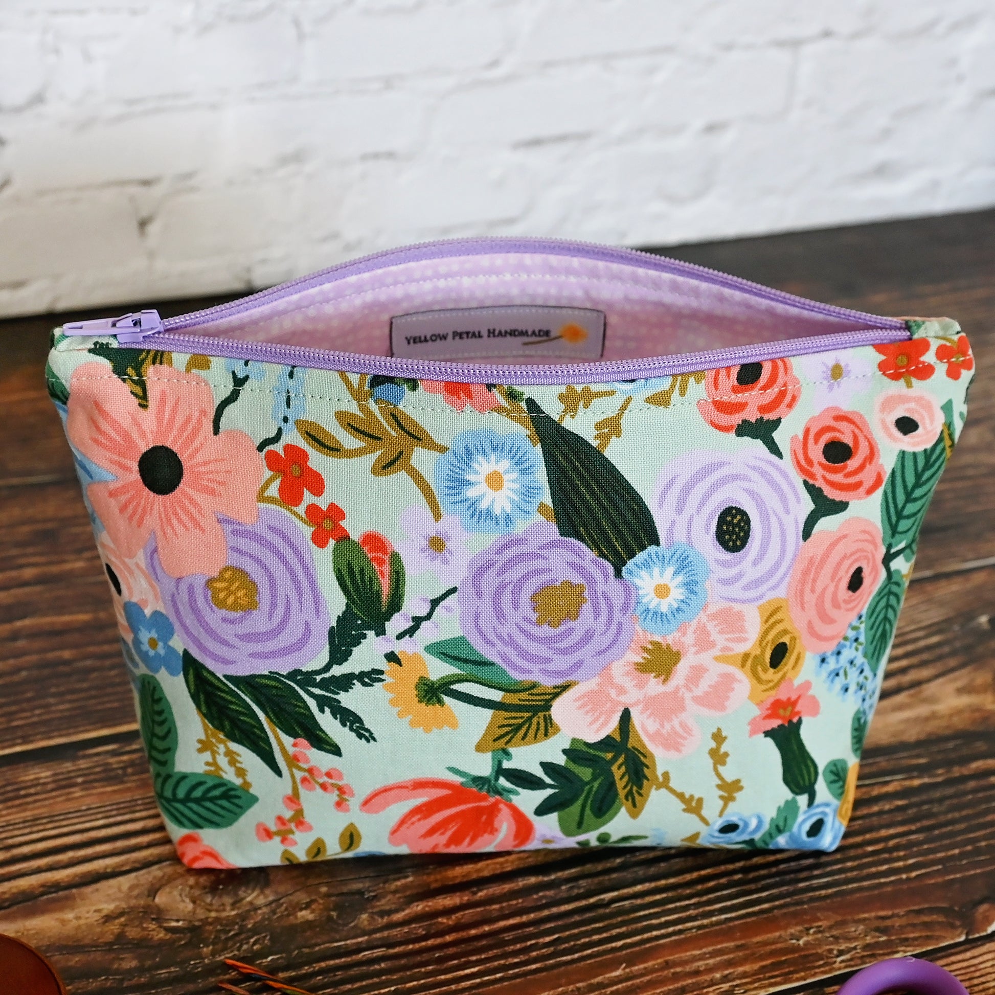 Aqua Floral accessory pouch in Rifle Paper's Garden Party fabric.  Lined in a pretty pale pink spotty fabric and closes with a lavendar zipper.  Made in Canada by Yellow Petal Handmade.