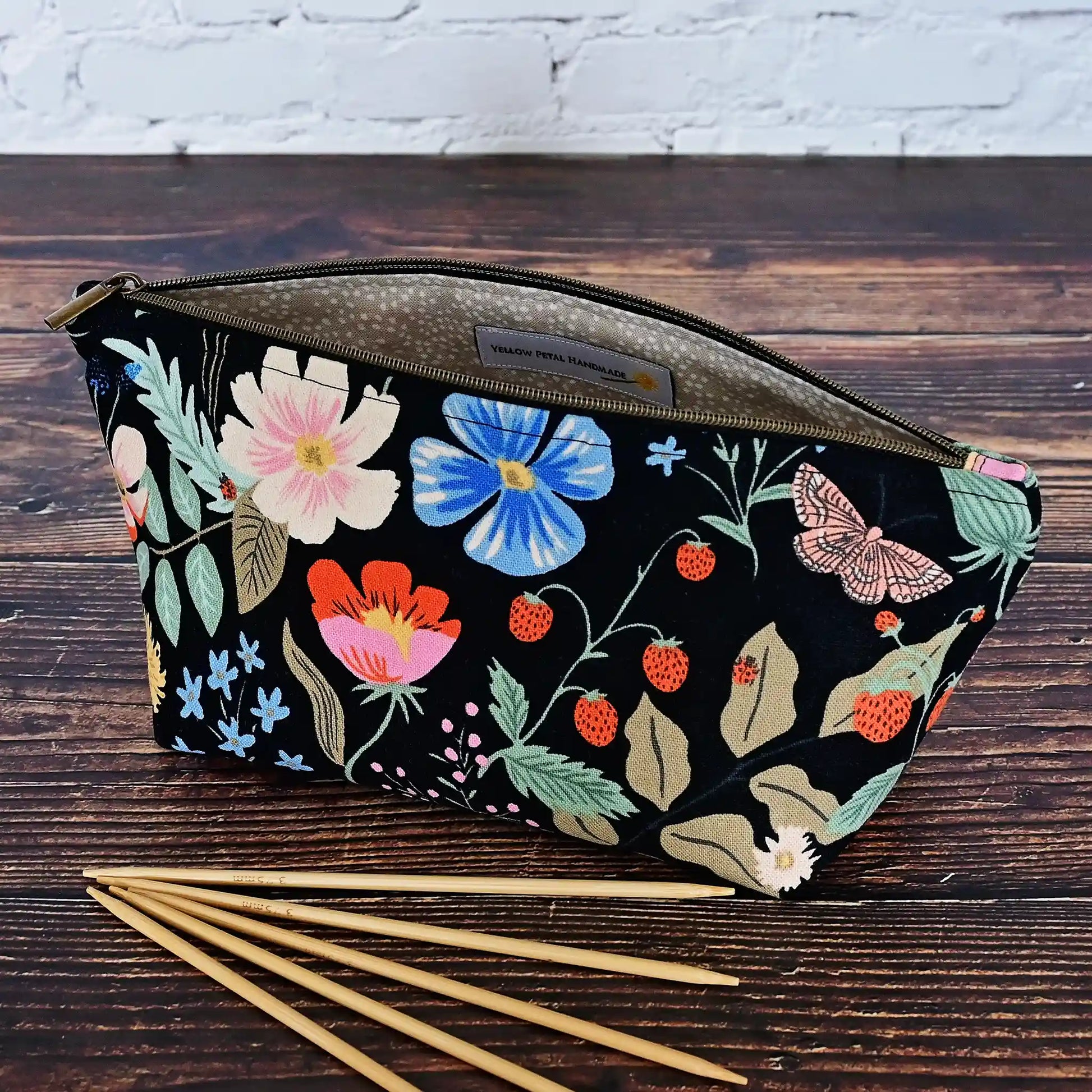 Cute black floral canvas accessory pouch in Rifle Paper Co's Strawberry Fields collection.  Shown with 6" dpns.  Made in Canada by Yellow Petal Handmade.