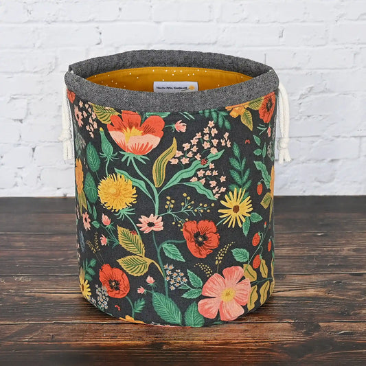 Black floral canvas bucket style project bag with pretty gold cotton interior.  Made from the Camont collection by Rifle Paper Co.  Made in Canada by Yellow Petal Handmade.