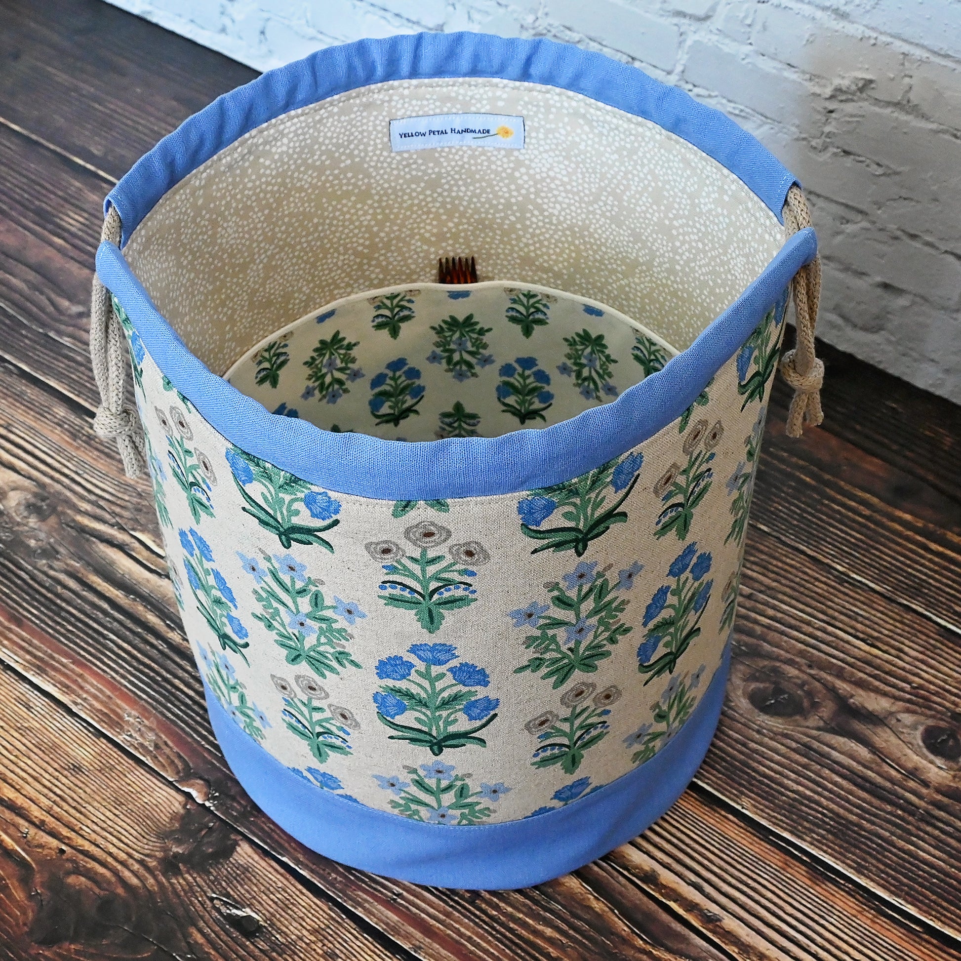 Canvas bucket bag in a pretty floral and periwinkle canvas/linen combinations.  Made with plenty of interior pockets and a quilted bottom for stability and design.  Made in Canada by Yellow Petal Handmade.