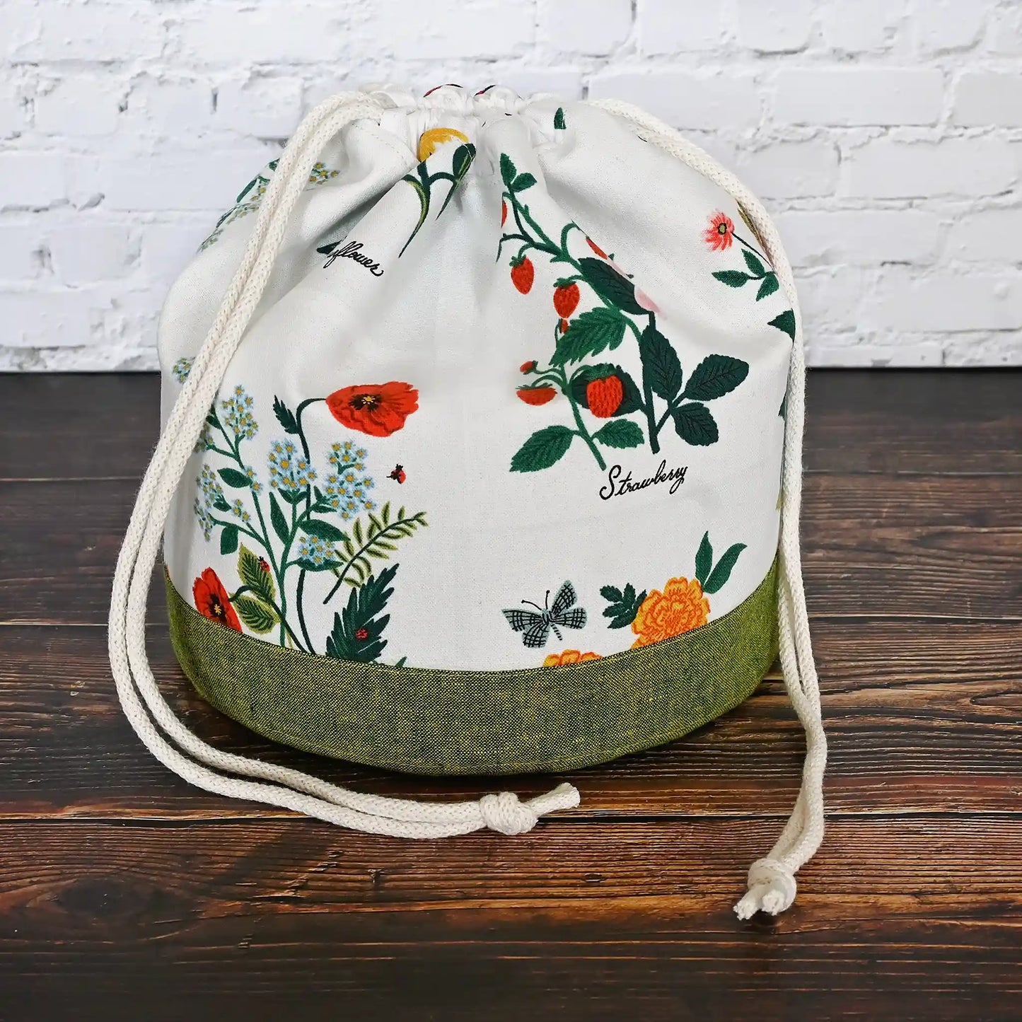 Stunning white floral project bag with green base and tons of pockets!  Great for needlework projects.  Made in Canada by Yellow Petal Handmade using Rifle Paper Co's Curio fabric collection.