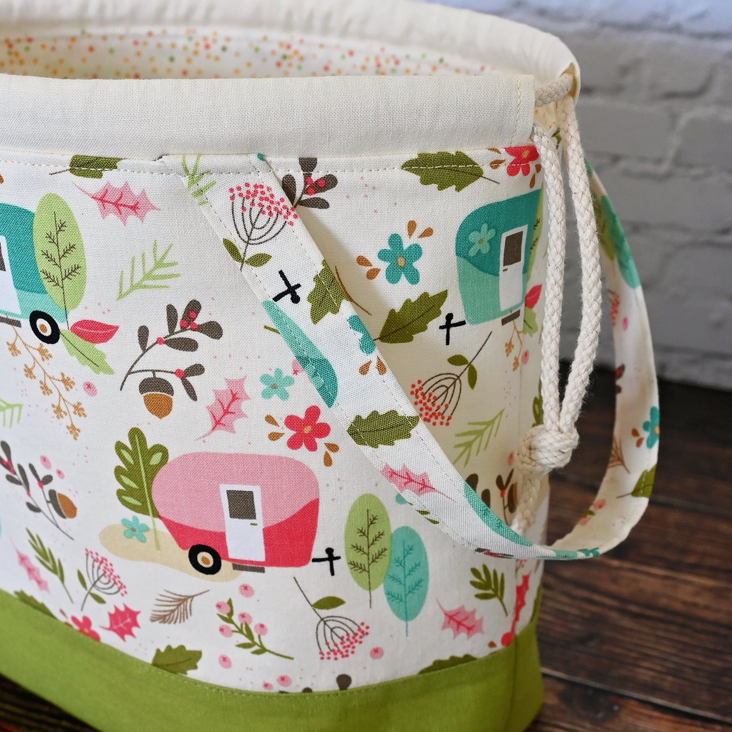 Cream and lime green camping themed project bag with a drawstring closure and carry handle.  The interior has a fun spotty print and pockets for storage.  Made in Nova Scotia, Canada by Yellow Petal Handmade.