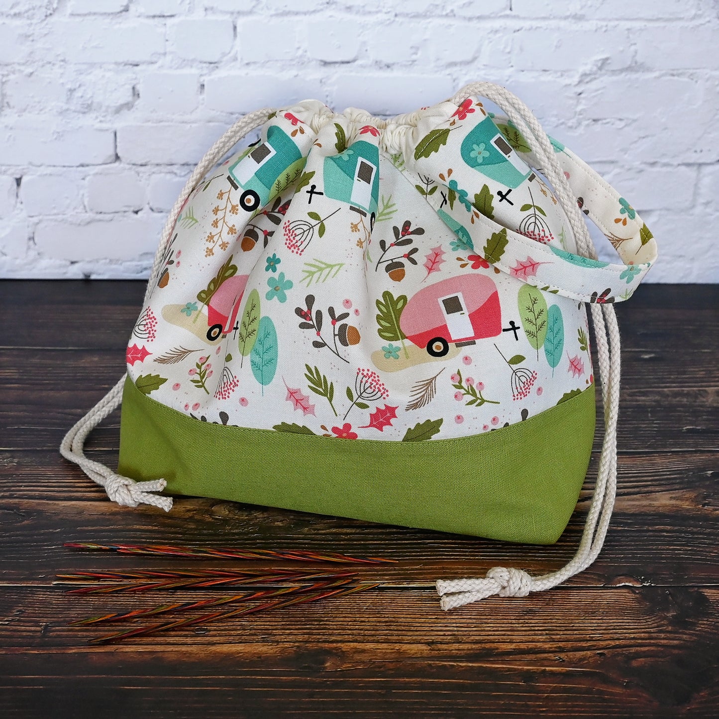 Cream and lime green camping themed project bag with a drawstring closure and carry handle.  The interior has a fun spotty print and pockets for storage.  Made in Nova Scotia, Canada by Yellow Petal Handmade.