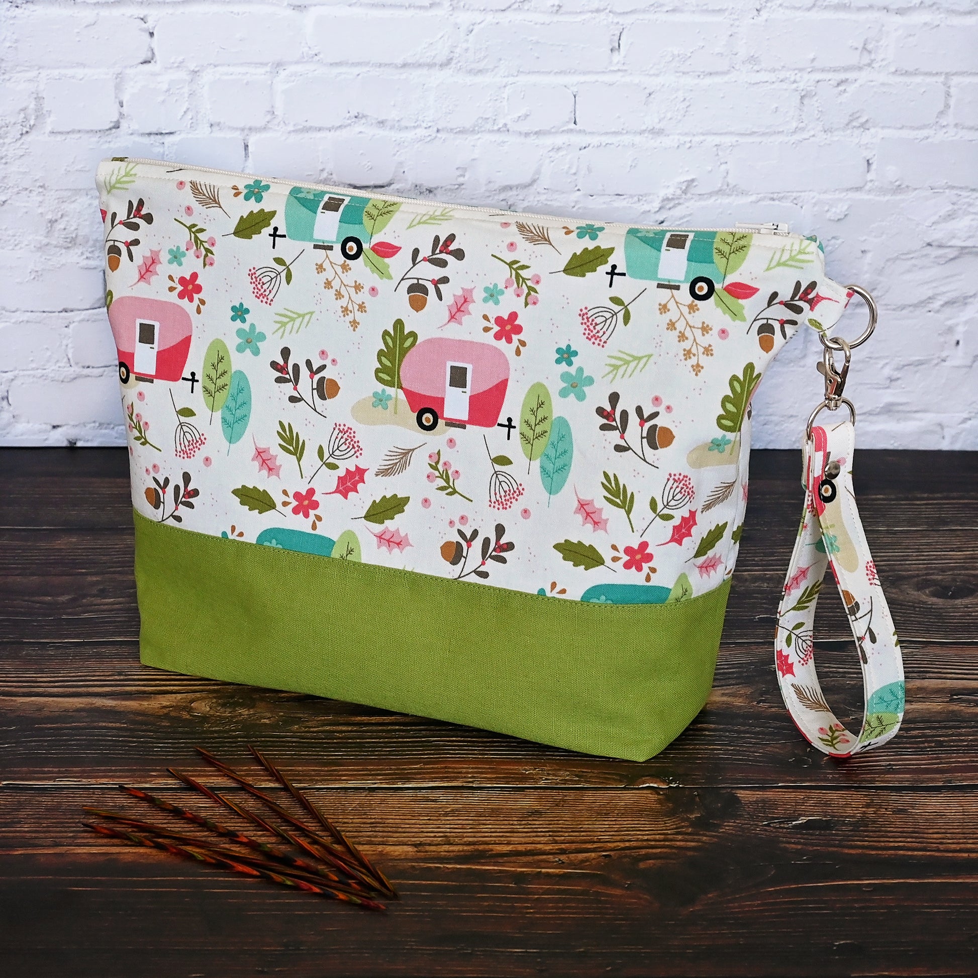 Cream and lime green camping themed project bag with a zipper closure and wrist strap.  The interior has a fun spotty print and pockets for storage.  Made in Nova Scotia, Canada by Yellow Petal Handmade.