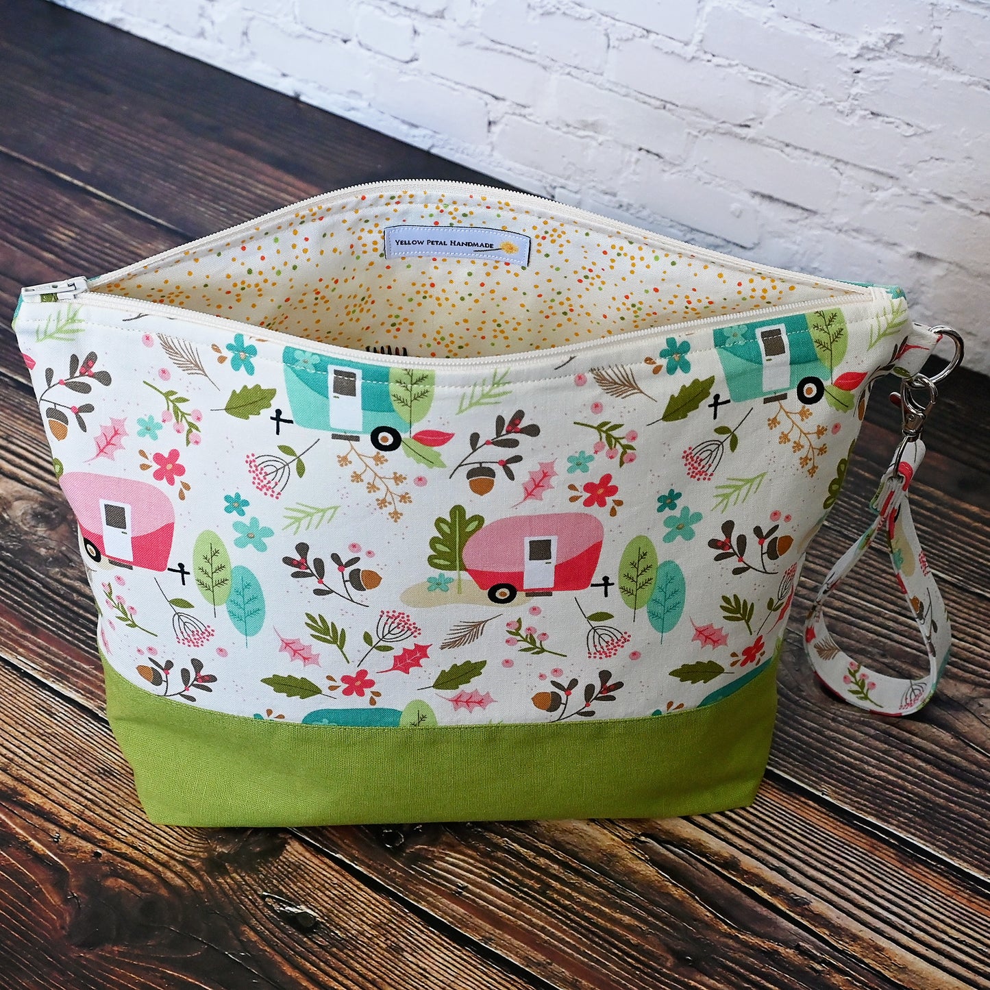 Cream and lime green camping themed project bag with a zipper closure and wrist strap.  The interior has a fun spotty print and pockets for storage.  Made in Nova Scotia, Canada by Yellow Petal Handmade.