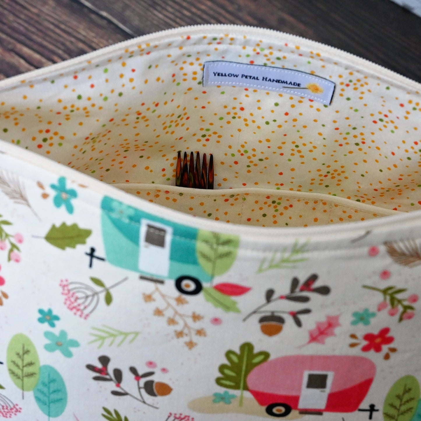 Cream and lime green camping themed project bag with a zipper closure and wrist strap.  The interior has a fun spotty print and pockets for storage.  Made in Nova Scotia, Canada by Yellow Petal Handmade.