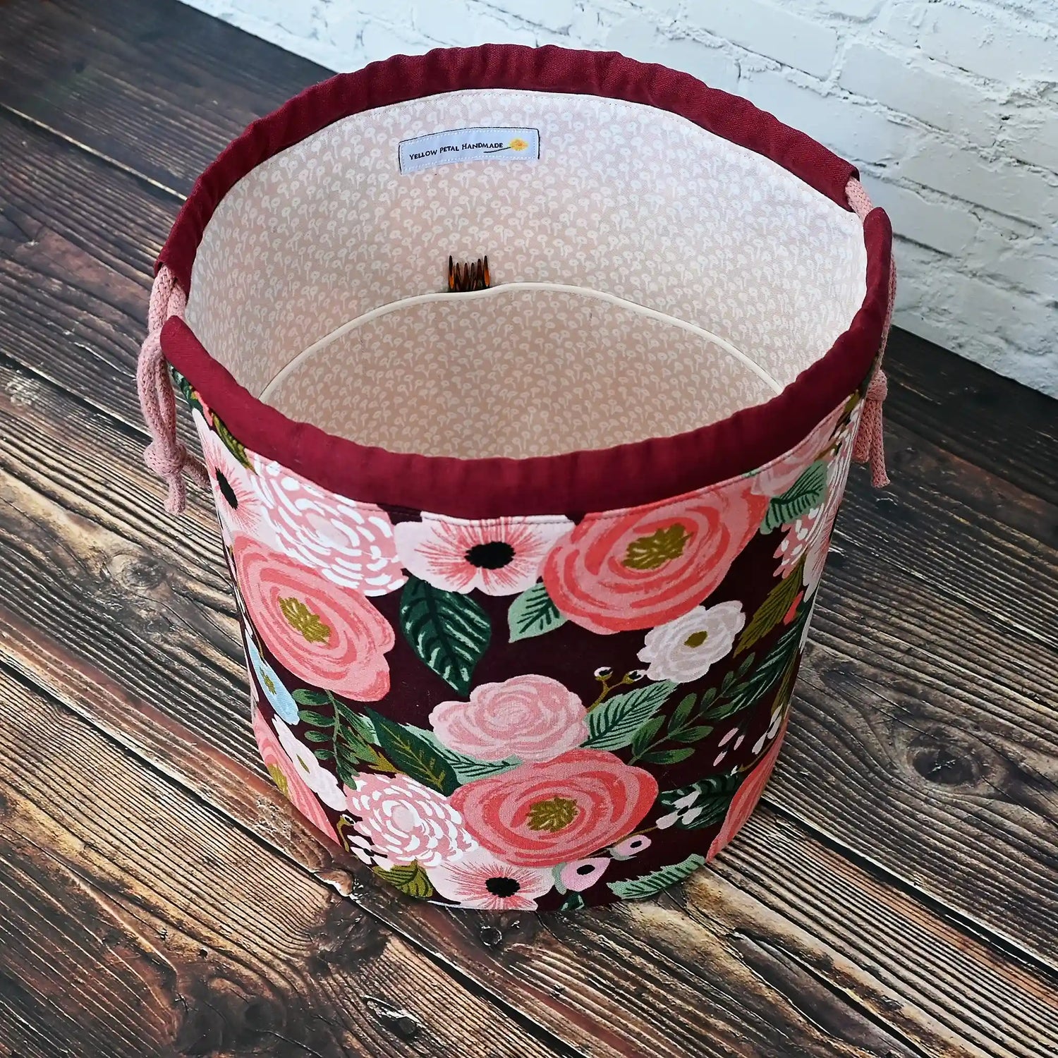 Beautiful burgundy floral bucket bag for knitting or crochet projects.  Made from canvas from the Garden Party collection by Rifle Paper Co and lined in  a pretty blush floral.  This bag has lots of pockets and is quilted on the bottom for stability and design.  Made in Canada by Yellow Petal Handmade.