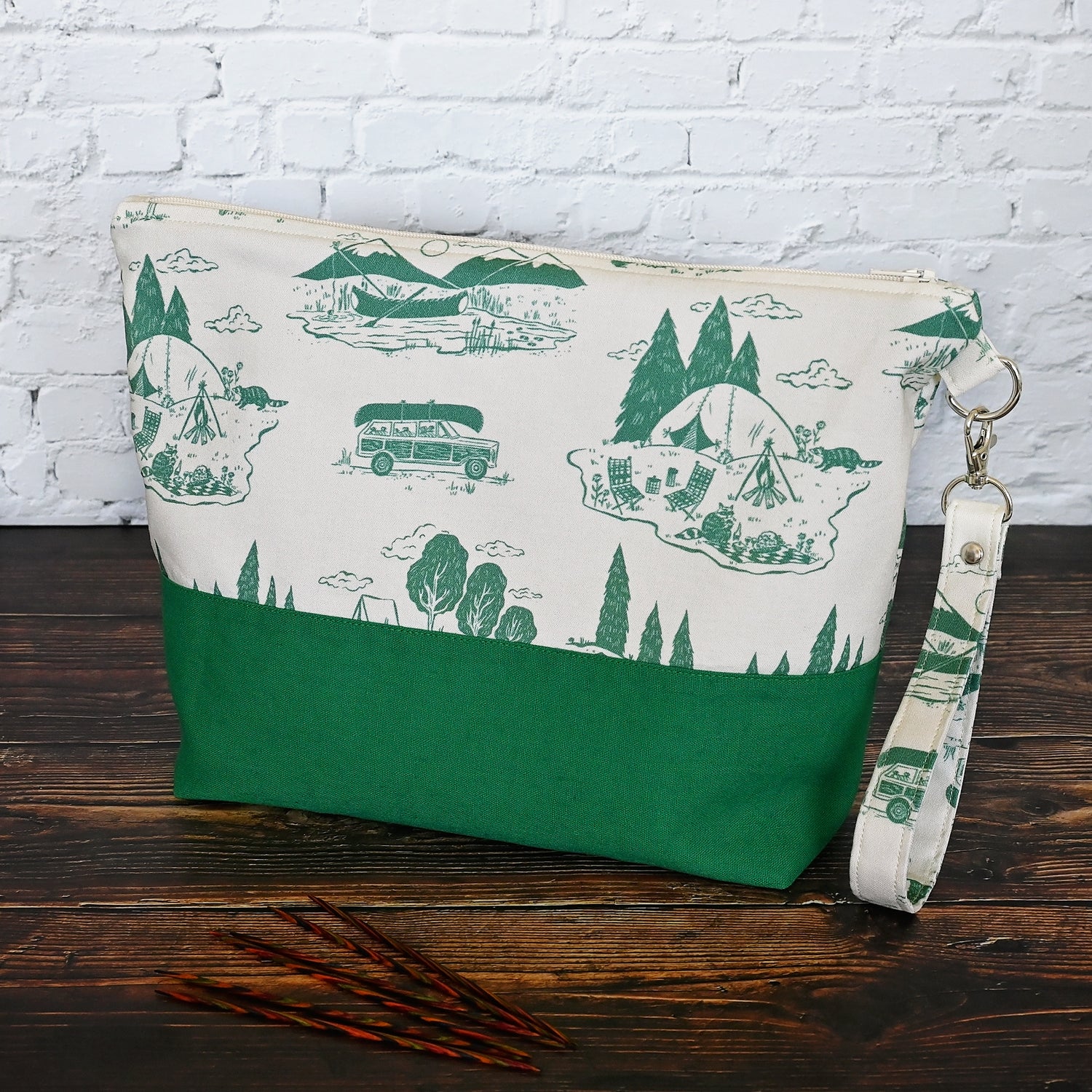 Classic Green and Cream project bag.  Made from a cream and green camping print and paired with a green linen on the exterior.  Lined in a pretty cream and green floral.  This bag comes with a removable wrist strap, and has multiple pockets for storage on the go.  Made in Canada by Yellow Petal Handmade.