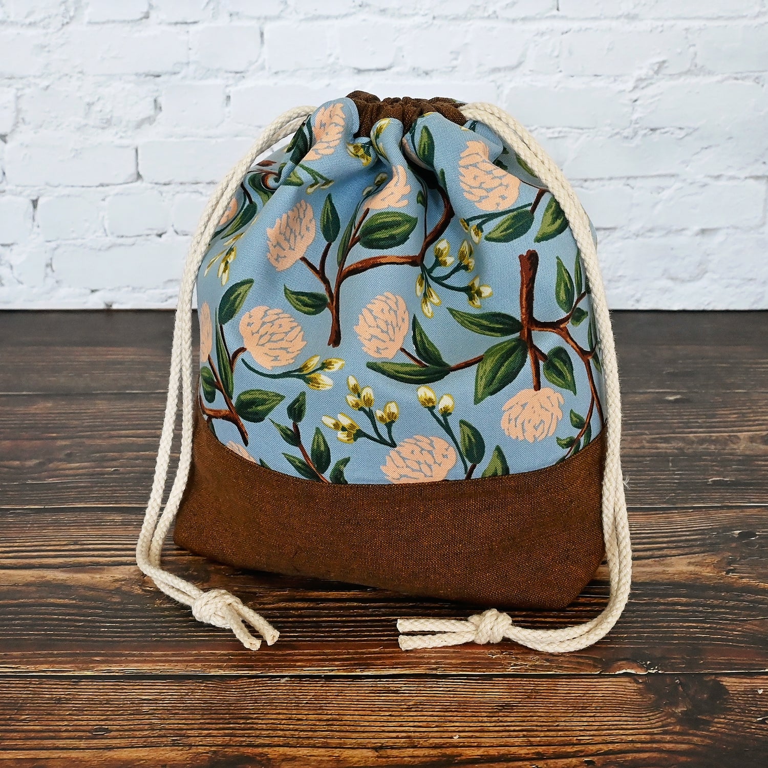 Pretty floral project bag in peonies fabric by Rifle Paper Co, paired with a lovely brown linen from Robert Kaufman.  This bag is lined with a pale peach fabric and closes securely with a double drawstring.  Made in Canada by Yellow Petal Handmade.