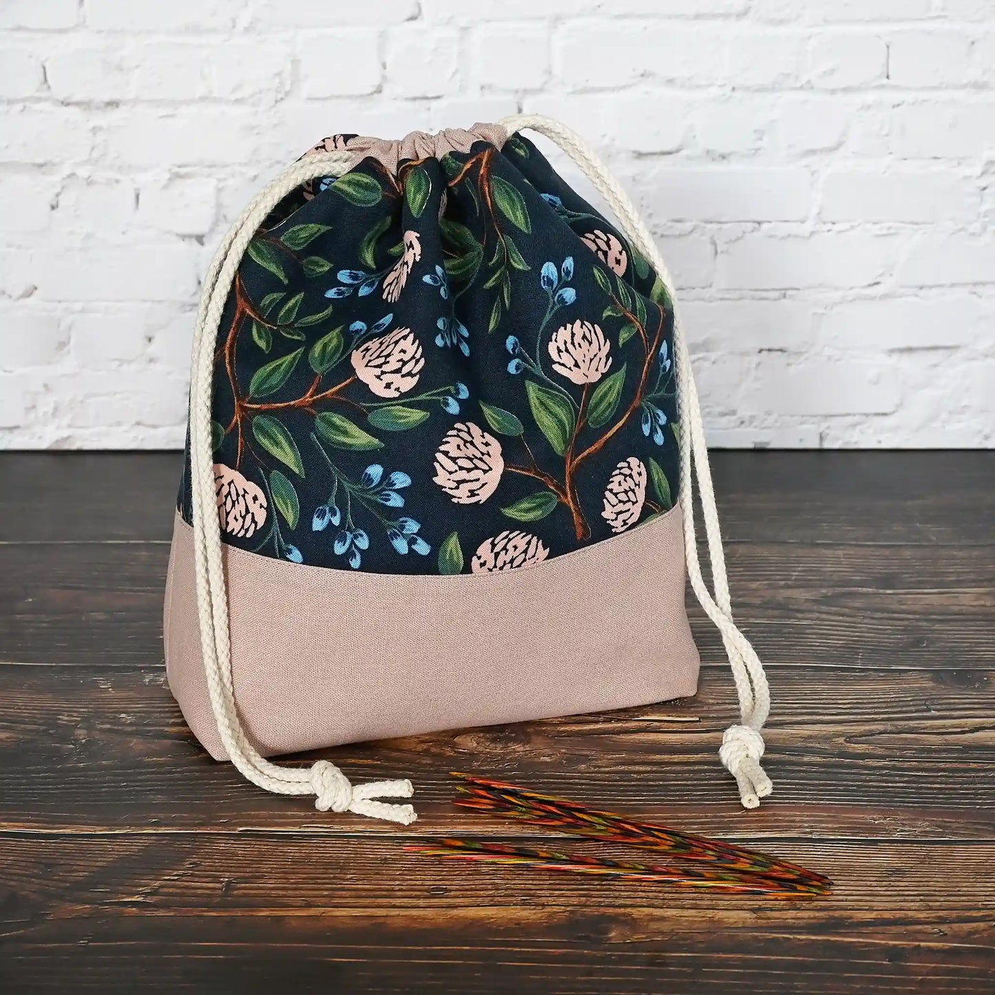 Pretty drawstring project bag made from a navy cotton with pink peonies and paired with a matching pink linen bottom.  Available with or without pockets.  Made by Yellow Petal Handmade in Nova Scotia, Canada.