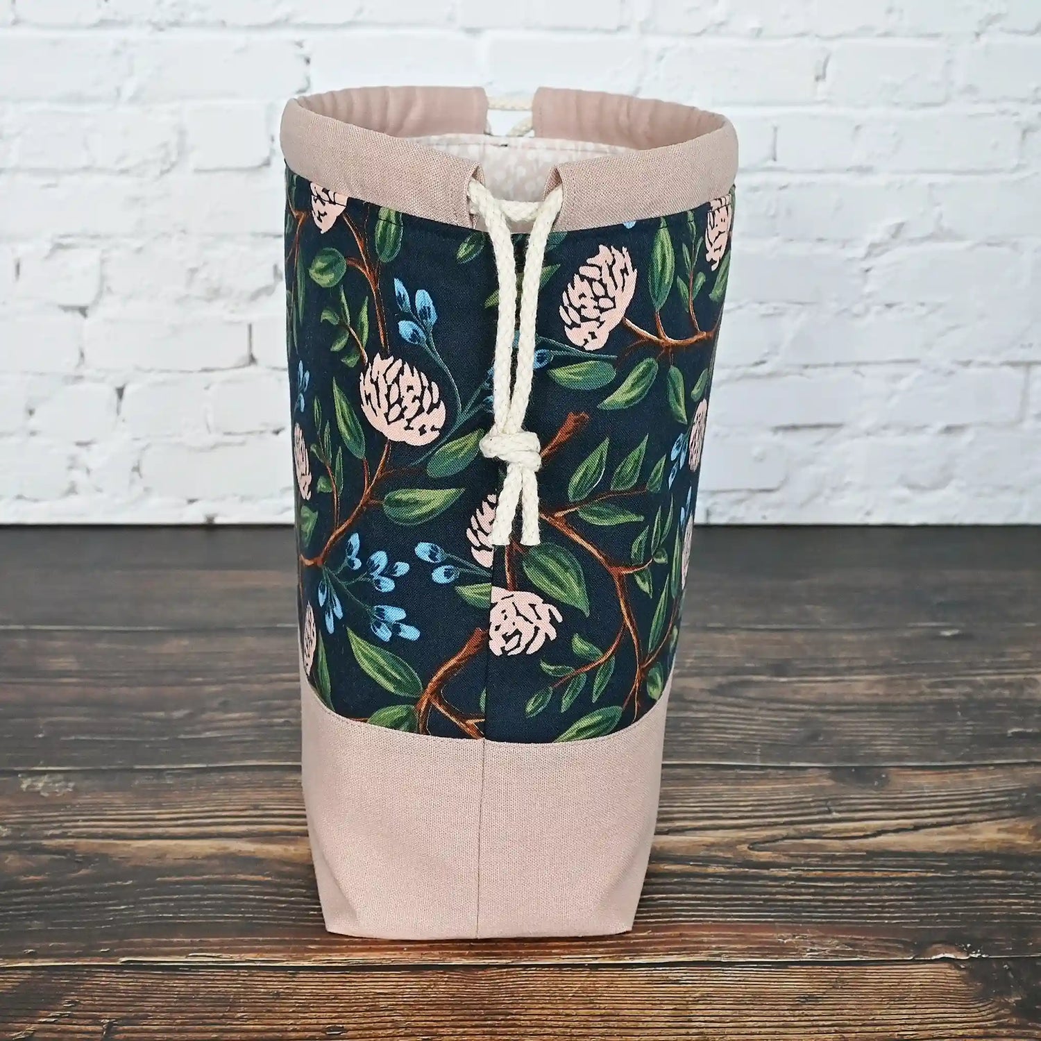 Pretty drawstring project bag made from a navy cotton with pink peonies and paired with a matching pink linen bottom.  Available with or without pockets.  Made by Yellow Petal Handmade in Nova Scotia, Canada.