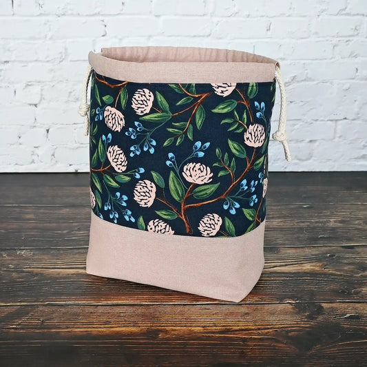 Pretty drawstring project bag made from a navy cotton with pink peonies and paired with a matching pink linen bottom.  Available with or without pockets.  Made by Yellow Petal Handmade in Nova Scotia, Canada.