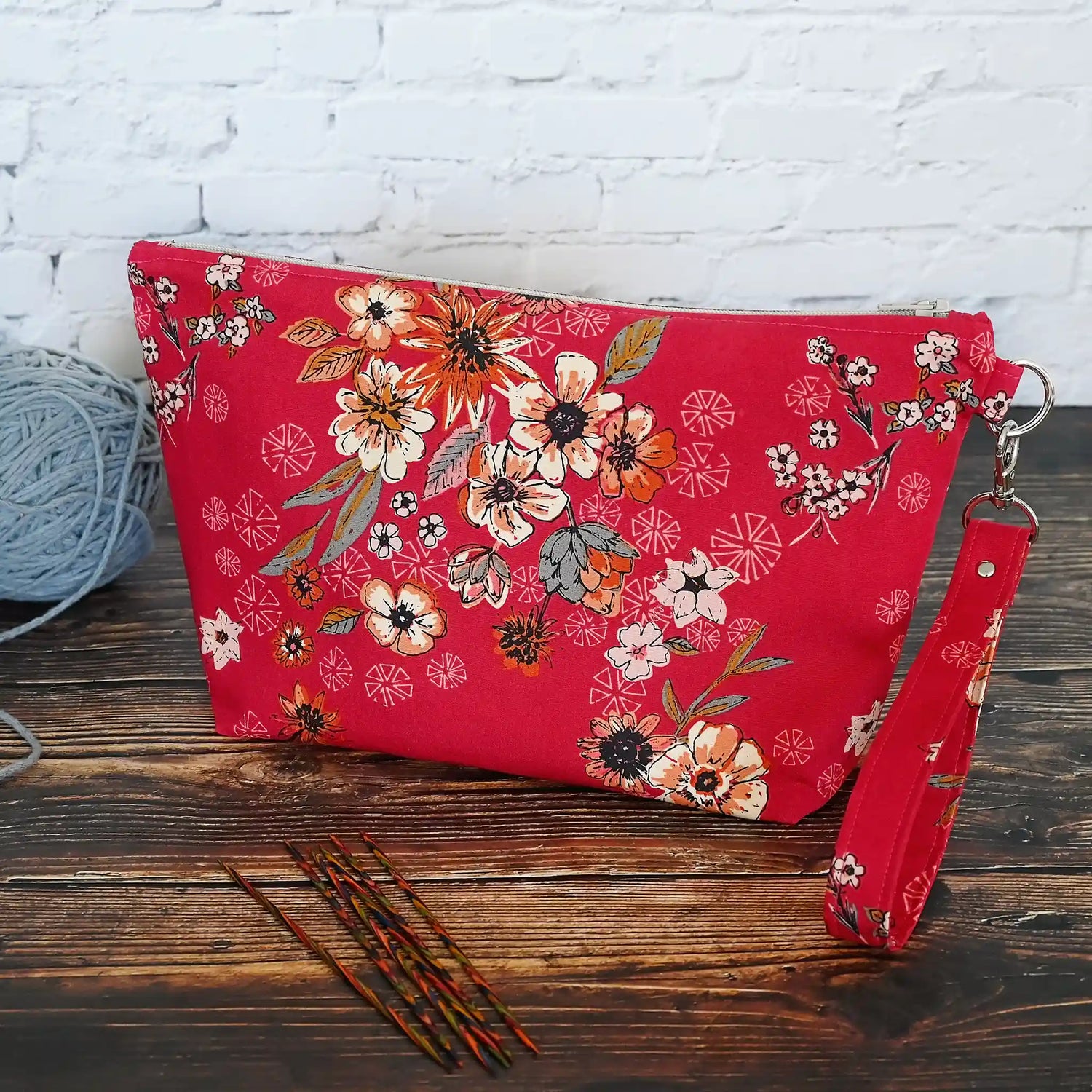 Red floral zippered pouch made from a gorgeous premium cotton from Art Gallery Fabrics.  Lined in a pretty cream and coral paisley floral and comes with a removable wrist strap.  Made in Canada by Yellow Petal Handmade.