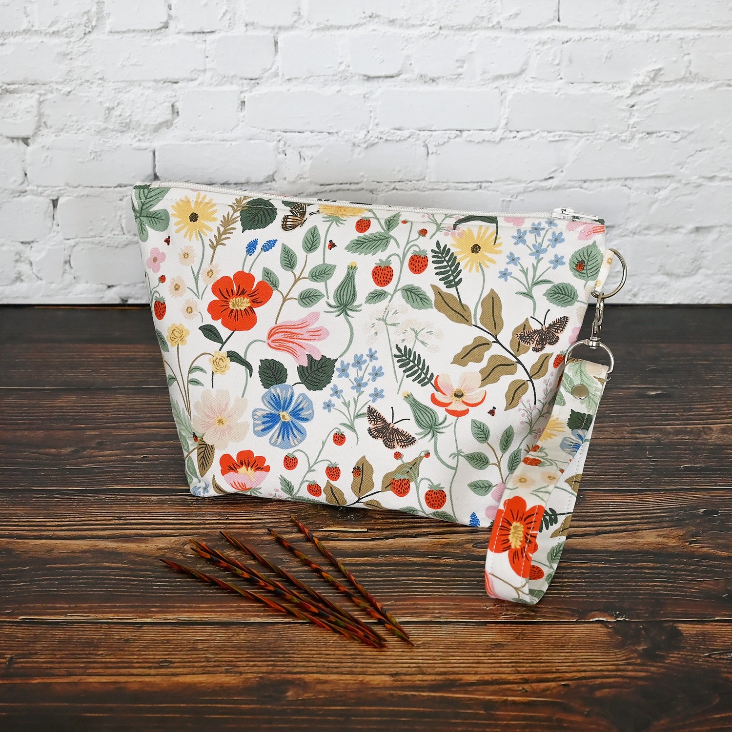 Pretty floral pouches in Rifle Paper Co's Strawberry Fields fabric.  Lined with a pretty pink and white floral lining.  These bags come with a removable wrist strap and a perfect for carrying small projects.