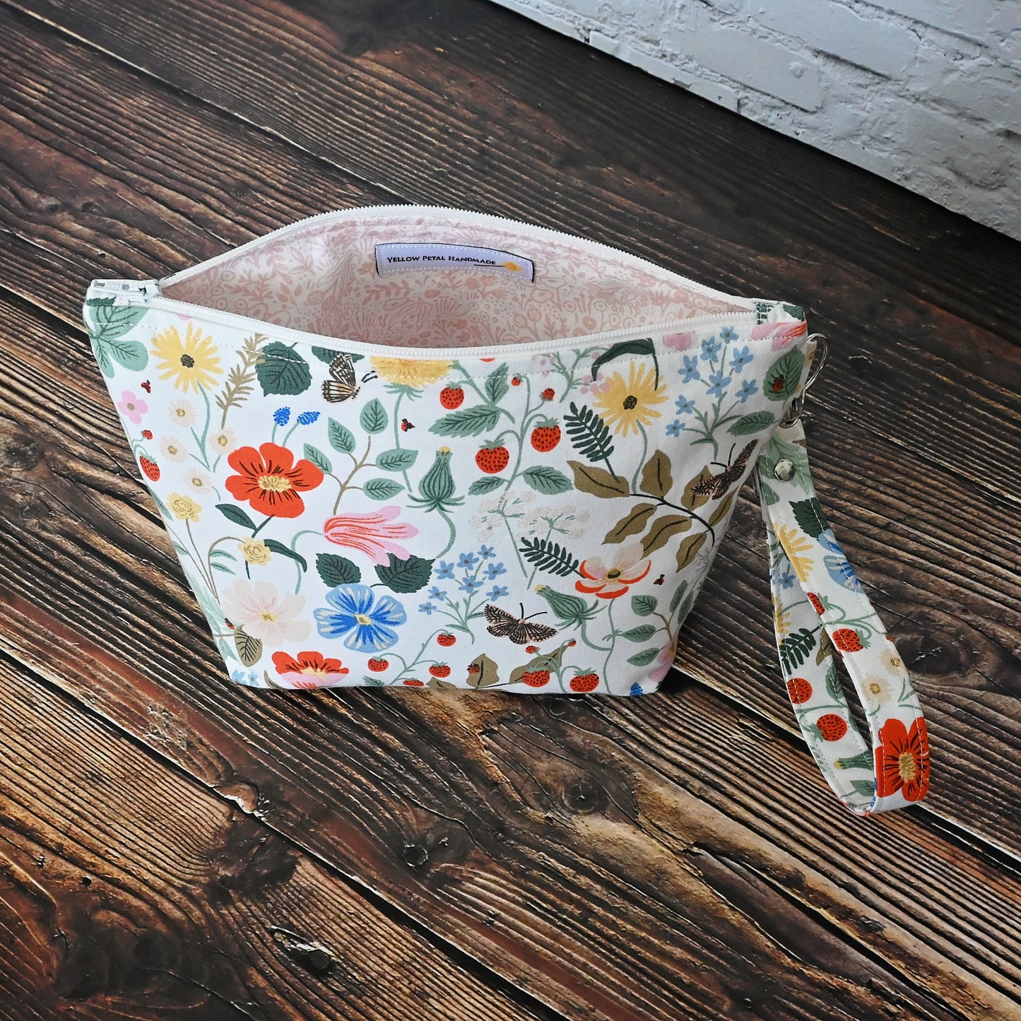 Pretty floral pouches in Rifle Paper Co's Strawberry Fields fabric.  Lined with a pretty pink and white floral lining.  These bags come with a removable wrist strap and a perfect for carrying small projects.