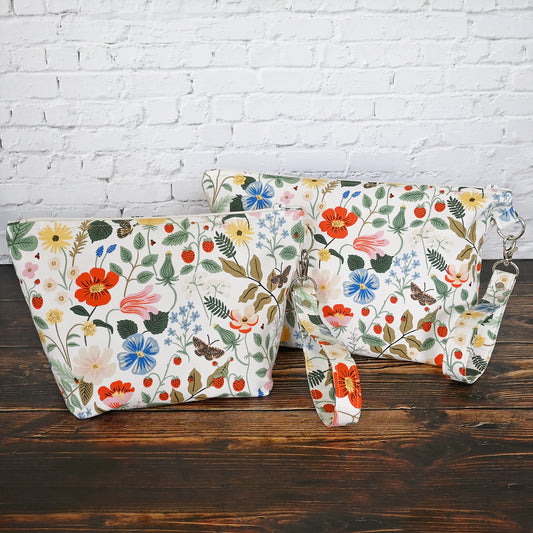 Pretty floral pouches in Rifle Paper Co's Strawberry Fields fabric.  Lined with a pretty pink and white floral lining.  These bags come with a removable wrist strap and a perfect for carrying small projects.