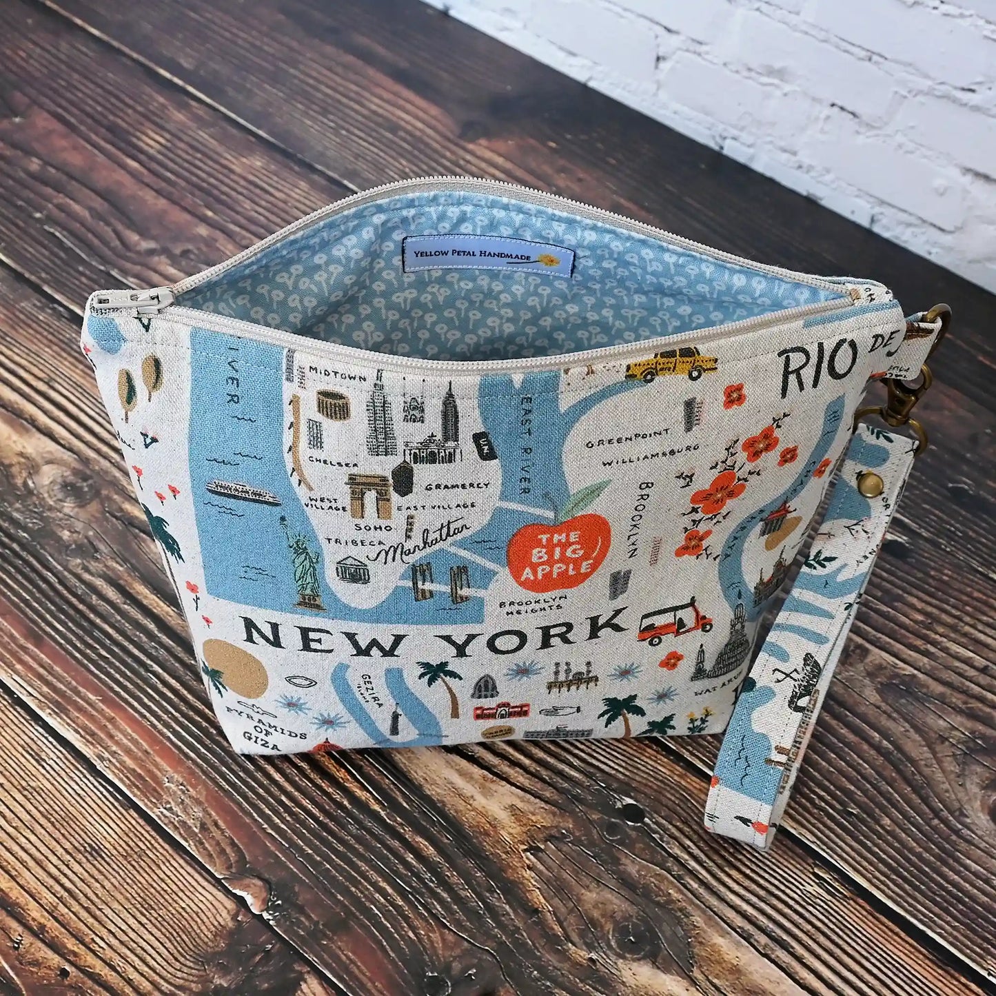 Adorable canvas travel sized project pouch made from Rifle Paper Co's Bon Voyage Collection.  Lined in a pretty blue floral, this pouch is a great size for on the go.  It comes with a removable wrist strap.  Made in Canada by Yellow Petal Handmade.