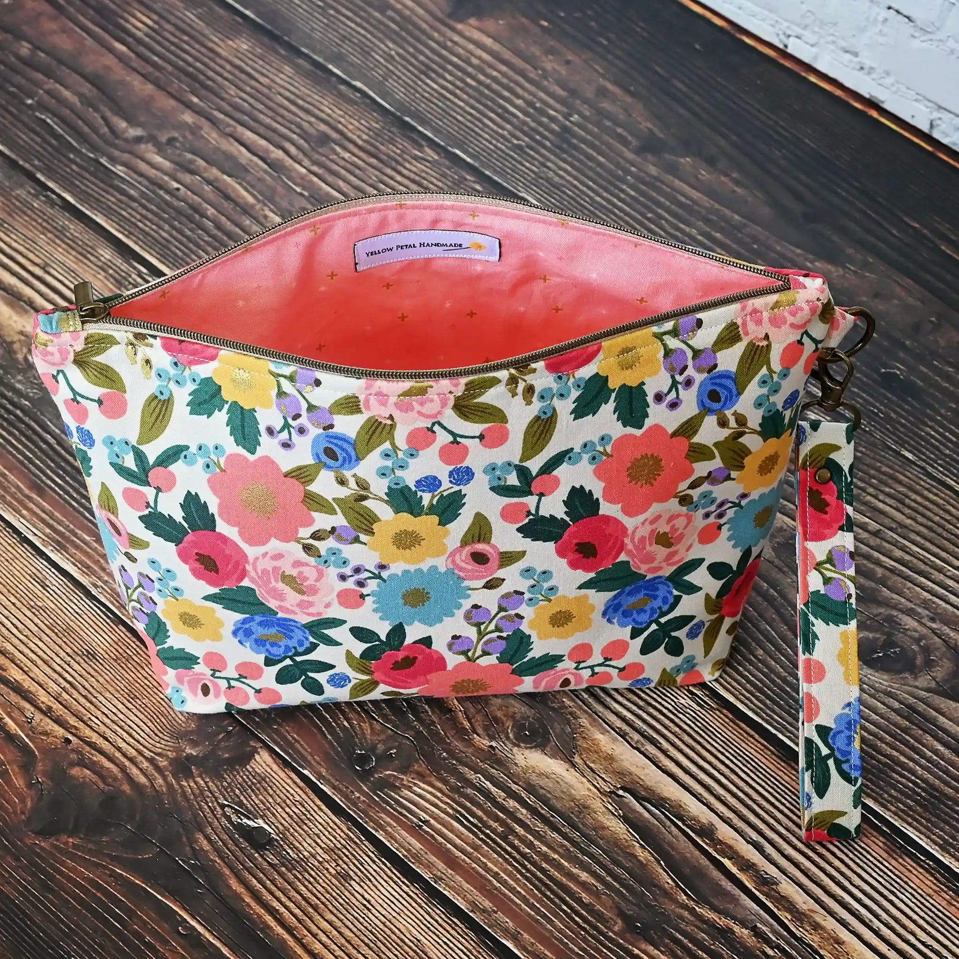 Pretty cream floral zippered pouch with wrist strap in fabrics from Rifle Paper Co's Antique Garden collection.  Handmade by Yellow Petal Handmade in Canada.