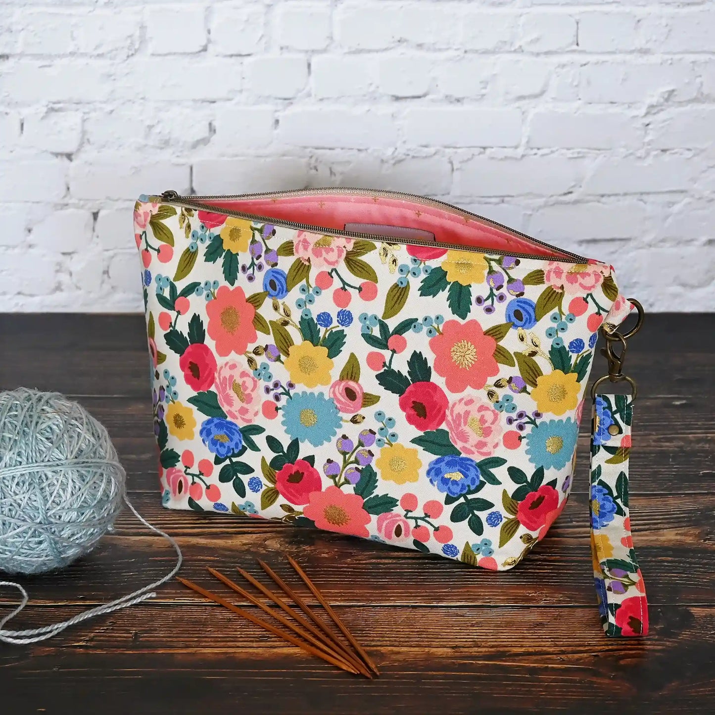 Pretty cream floral zippered pouch with wrist strap in fabrics from Rifle Paper Co's Antique Garden collection.  Handmade by Yellow Petal Handmade in Canada.