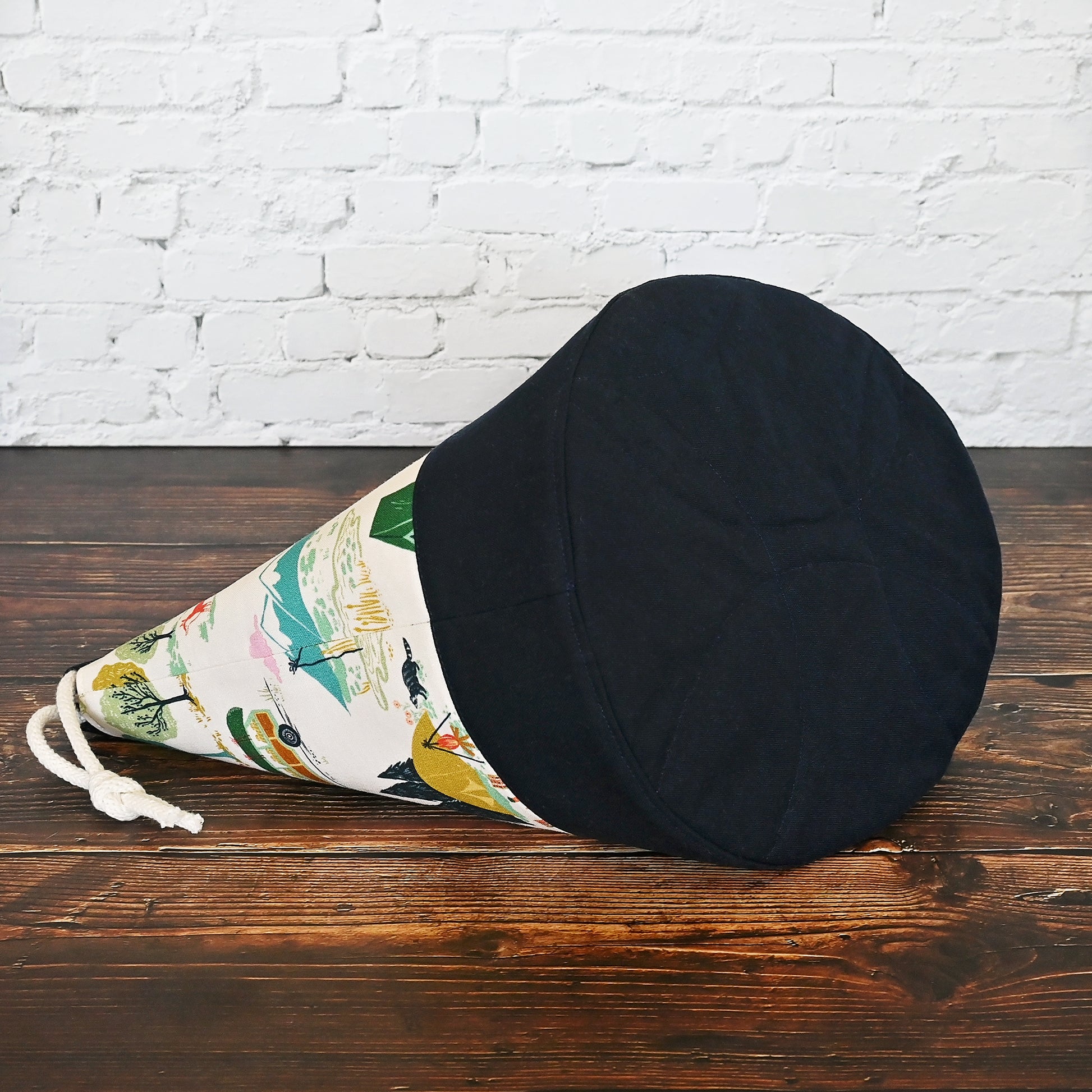 Fun vintage inspired drawstring bucket bag with lots of pockets.  Perfect for knitting or crochet projects.  Made from a fun camper and vintage car themed cream cotton and paired with a navy linen.  Made in Canada by Yellow Petal Handmade.