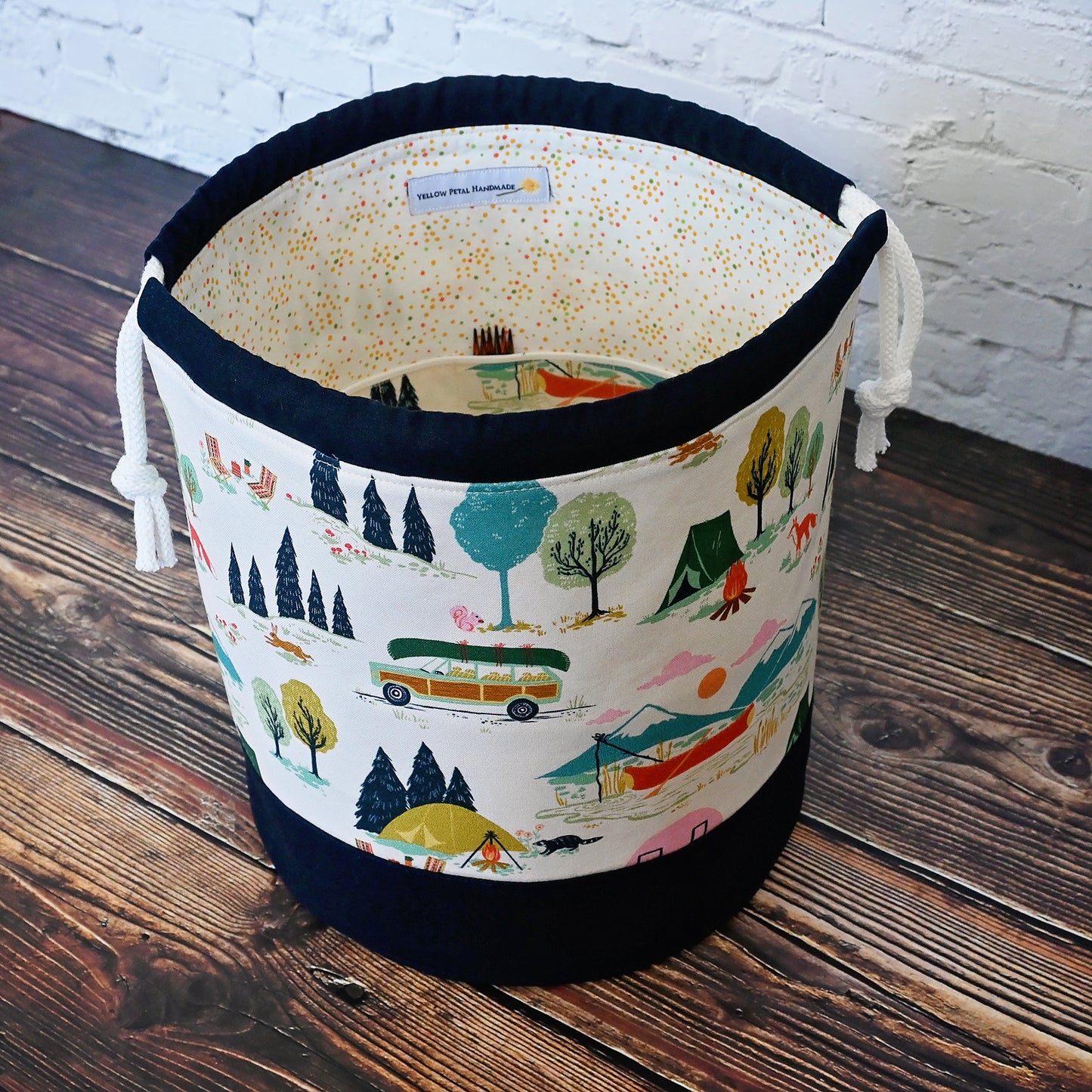 Fun vintage inspired drawstring bucket bag with lots of pockets.  Perfect for knitting or crochet projects.  Made from a fun camper and vintage car themed cream cotton and paired with a navy linen.  Made in Canada by Yellow Petal Handmade.