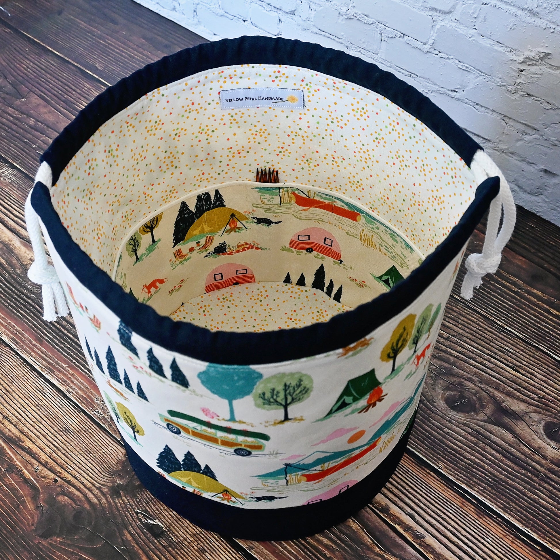 Fun vintage inspired drawstring bucket bag with lots of pockets.  Perfect for knitting or crochet projects.  Made from a fun camper and vintage car themed cream cotton and paired with a navy linen.  Made in Canada by Yellow Petal Handmade.