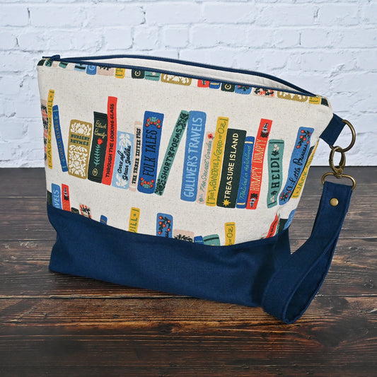 Fun project bag in Rifle Paper's Book Club Canvas.  Paried with a lovely navy linen and lined in an unbleached cotton with cotton Book Club Pockets.  Comes with a removable wrist strap.  Made in Canada by Yellow Petal Handmade.