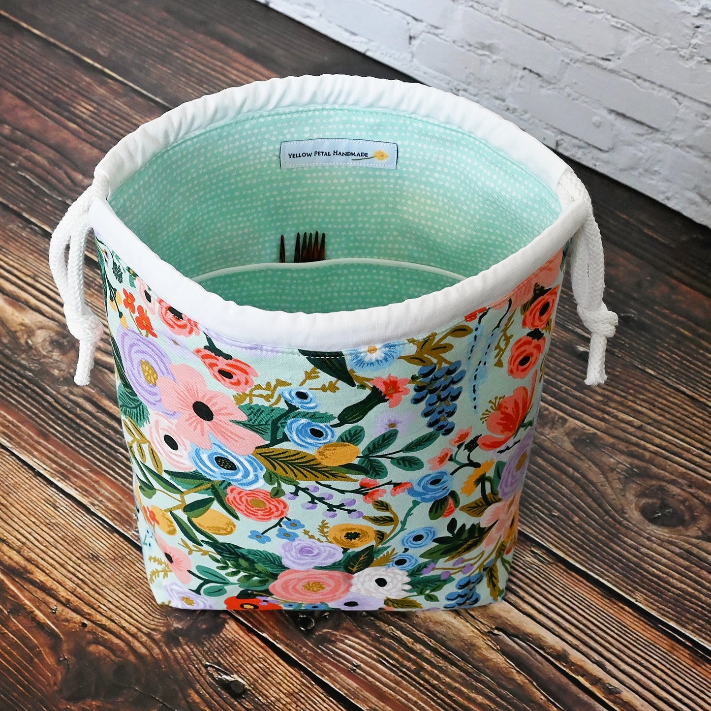 Pretty mint floral drawstring knitting bag made in a lovely cotton from Rifle Paper's newest Garden Party collection.  It's lined in a lovely spotted mint cotton and is available with or without pockets.  Closes securely with a double drawstring.  Made in Canada by Yellow Petal Handmade.