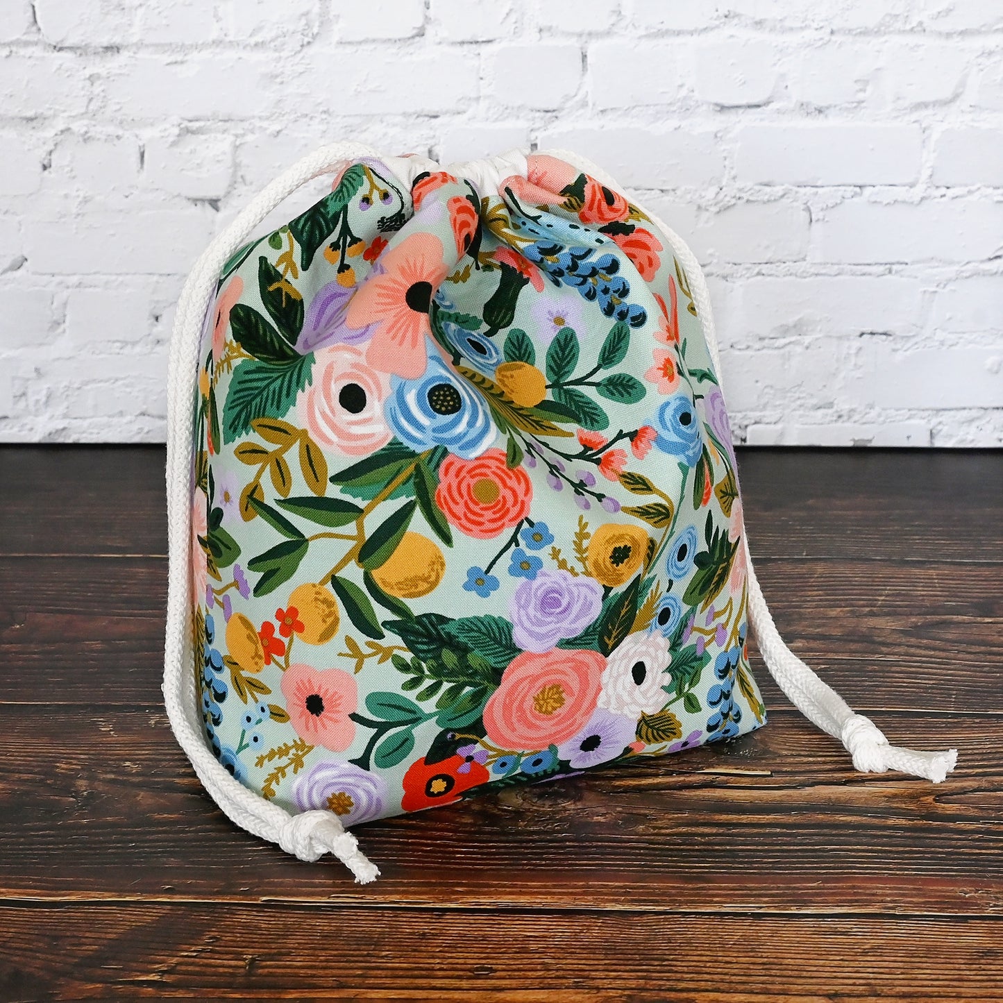 Pretty mint floral drawstring knitting bag made in a lovely cotton from Rifle Paper's newest Garden Party collection.  It's lined in a lovely spotted mint cotton and is available with or without pockets.  Closes securely with a double drawstring.  Made in Canada by Yellow Petal Handmade.