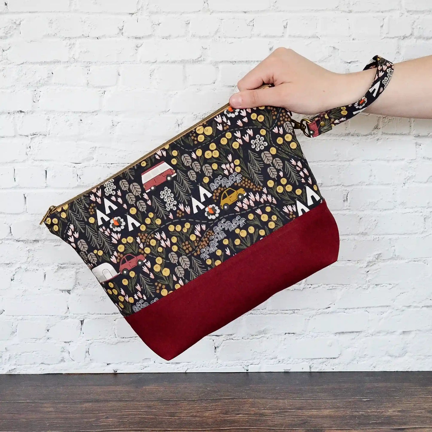 Camping themed project bag with pockets.  Made from a black camping fabric with a burgundy linen.  Made in Nova Scotia, Canada.