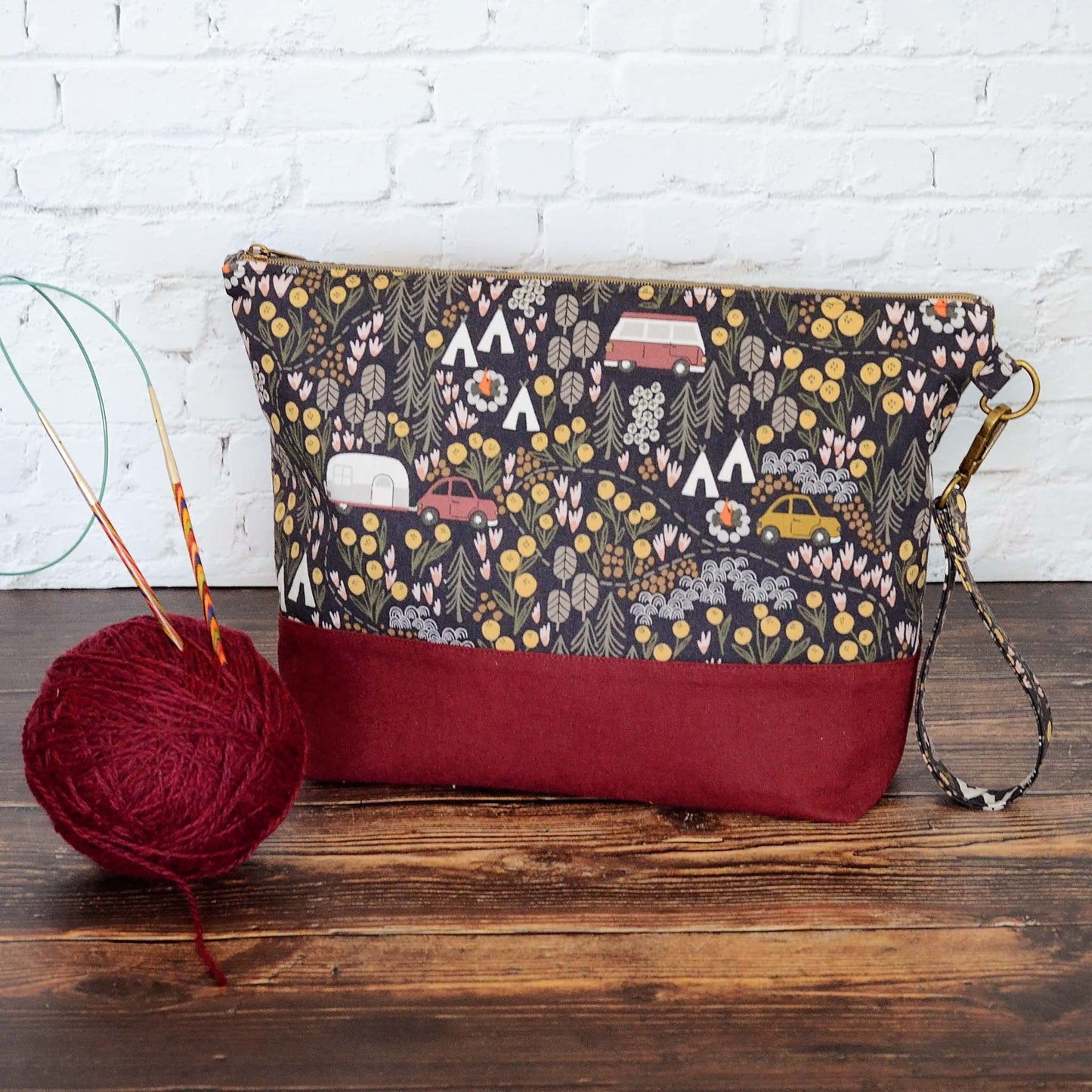 Camping themed project bag with pockets.  Made from a black camping fabric with a burgundy linen.  Made in Nova Scotia, Canada.