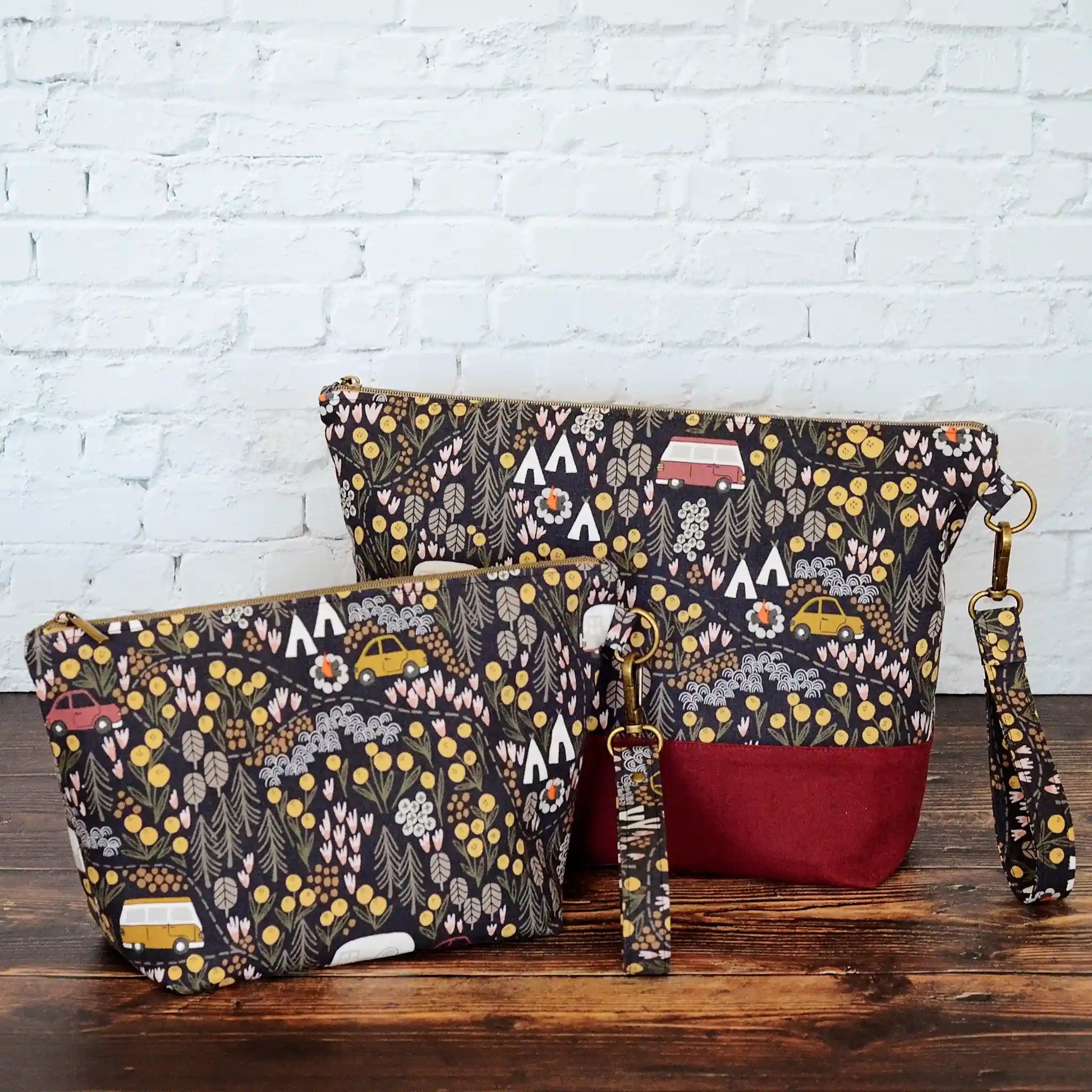 Camping themed project bag with pockets.  Made from a black camping fabric with a burgundy linen.  Made in Nova Scotia, Canada.