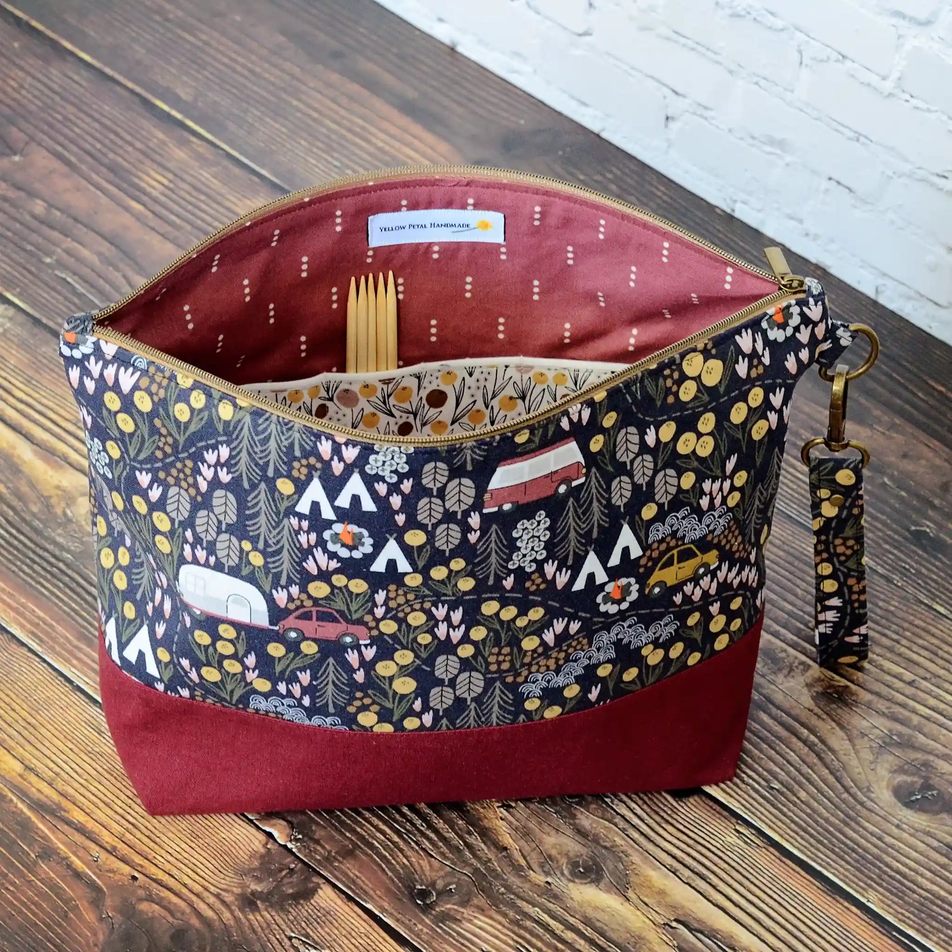 Camping themed project bag with pockets.  Made from a black camping fabric with a burgundy linen.  Made in Nova Scotia, Canada.