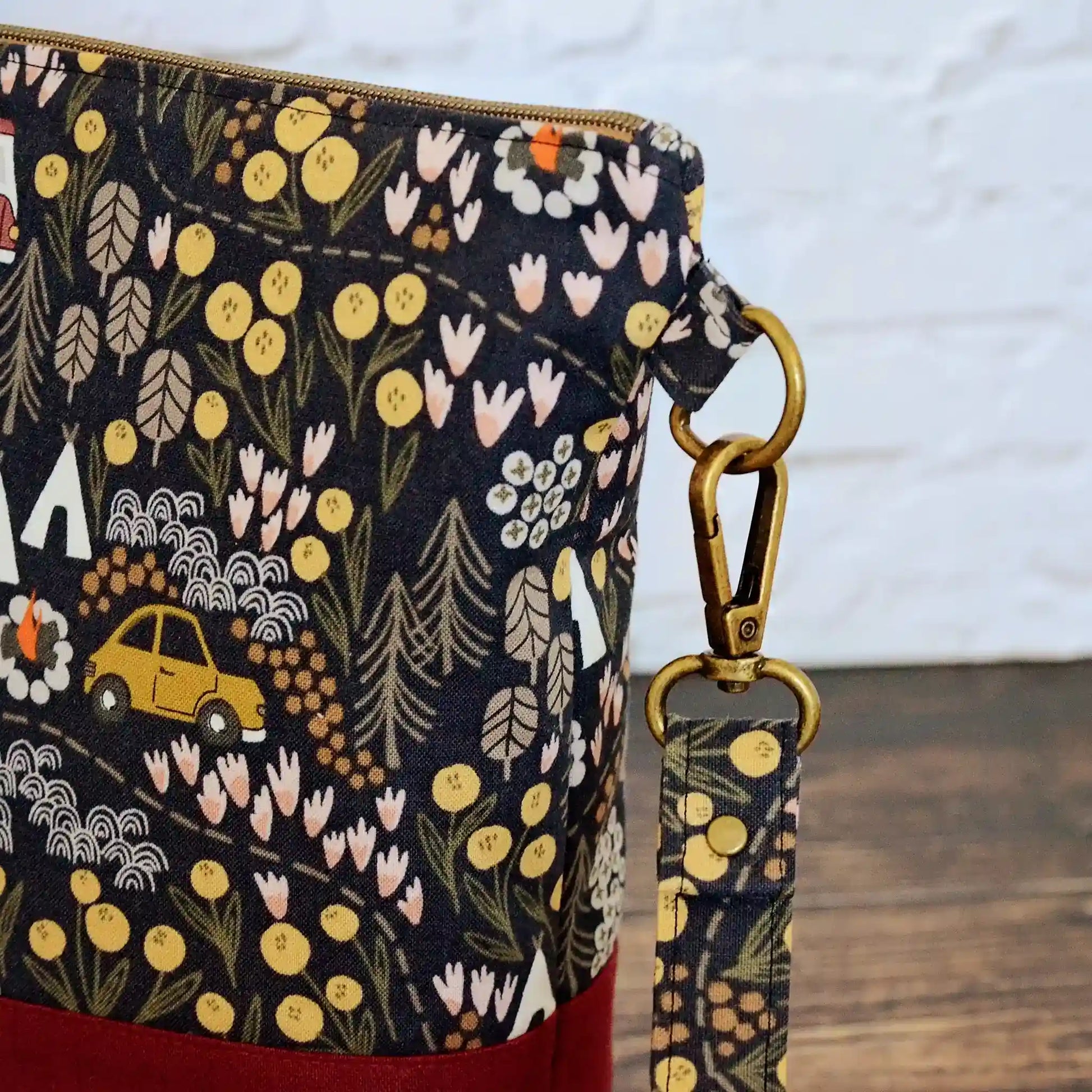 Camping themed project bag with pockets.  Made from a black camping fabric with a burgundy linen.  Made in Nova Scotia, Canada.