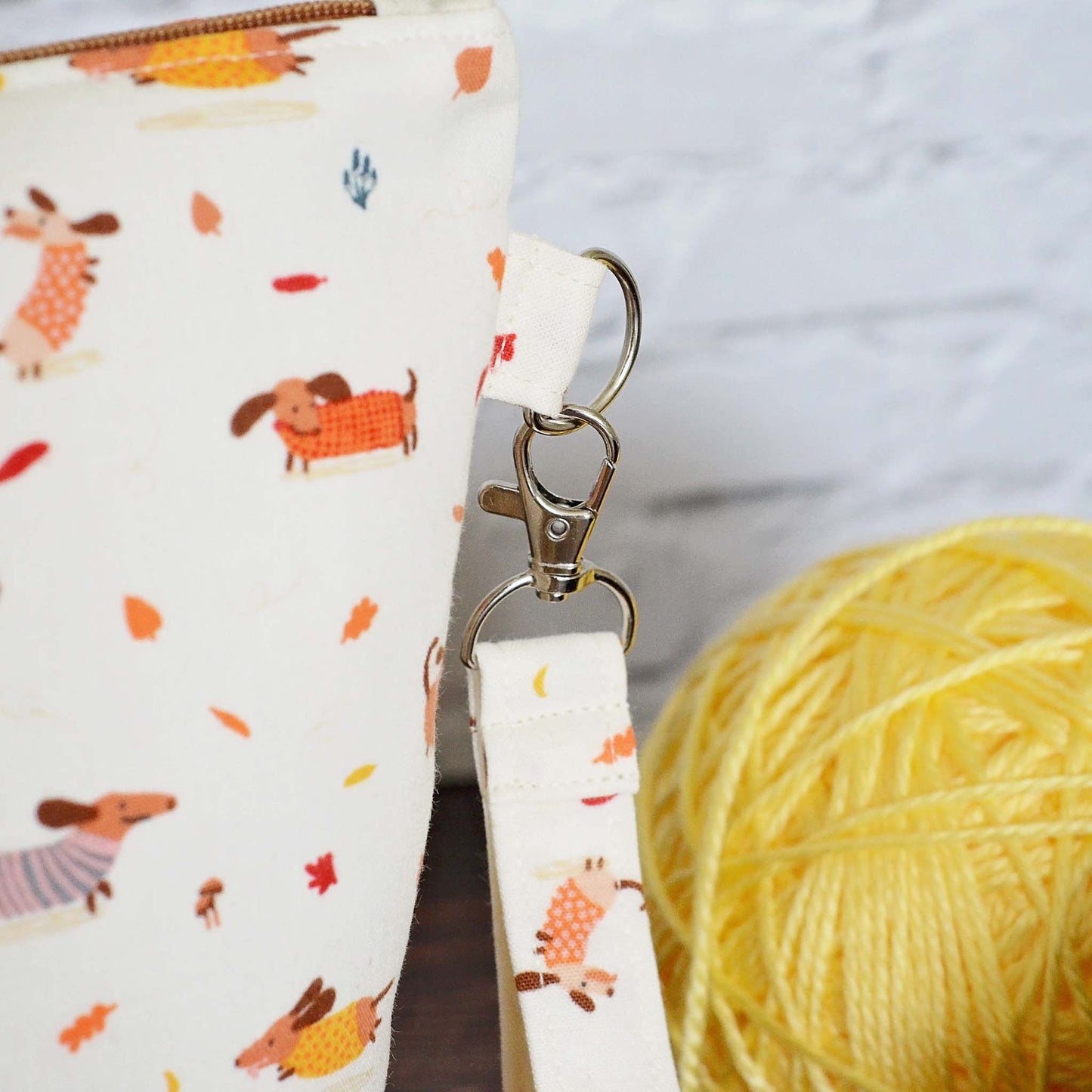 Fall themed knitting project bag with cute dogs and leaves.  Comes with a removable wrist strap.  Handmade in Nova Scotia, Canada by Yellow Petal Handmade.