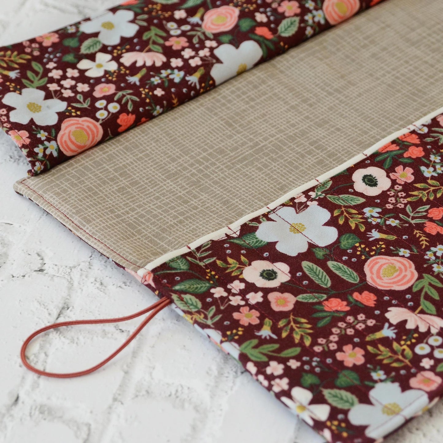 Quilted crochet hook wrap in burgundy floral Rifle Paper Co fabric.  Made in Canada by Yellow Petal Handmade.